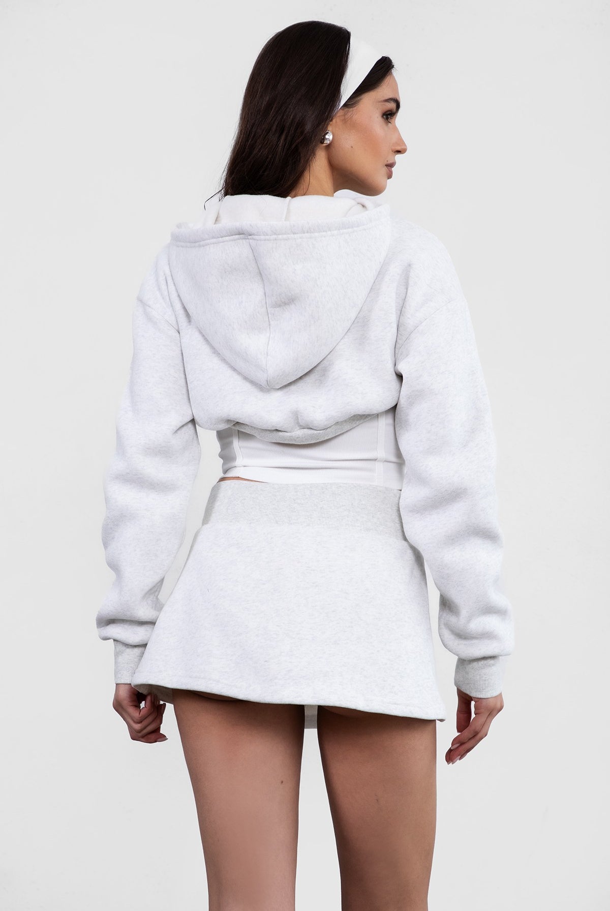 heather White fleece bolero-style cardigan featuring a cropped fit and zipper front by Tic Toc.