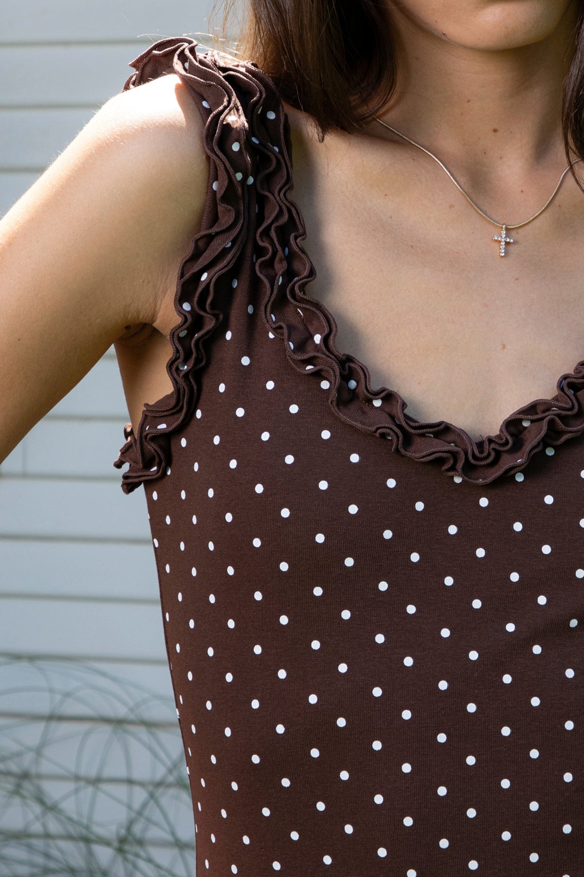 Woman wearing MOXI ruffle polka dot stretch mini dress featuring soft stretch cotton jersey fabric, allover polka dot print, scoop neckline with layered ruffle trim, wide ruffled shoulder straps, fitted bodice, softly flared skirt, and double ruffle trim along the mini hem.