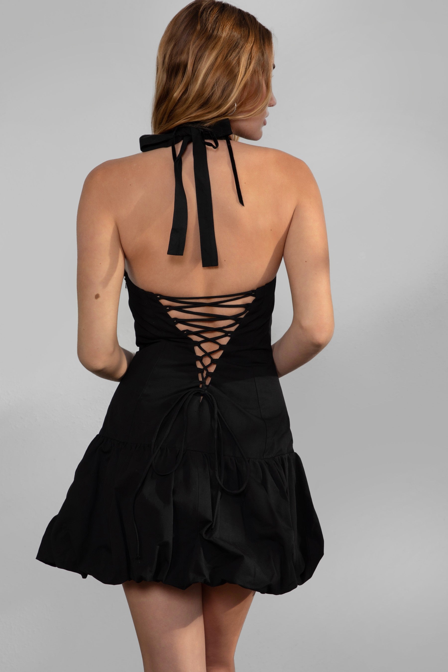 TIC TOC DH30936 DOLY Mini Dress featuring halter neckline, lace-up open back, and bubble hem in stretch twill fabric.