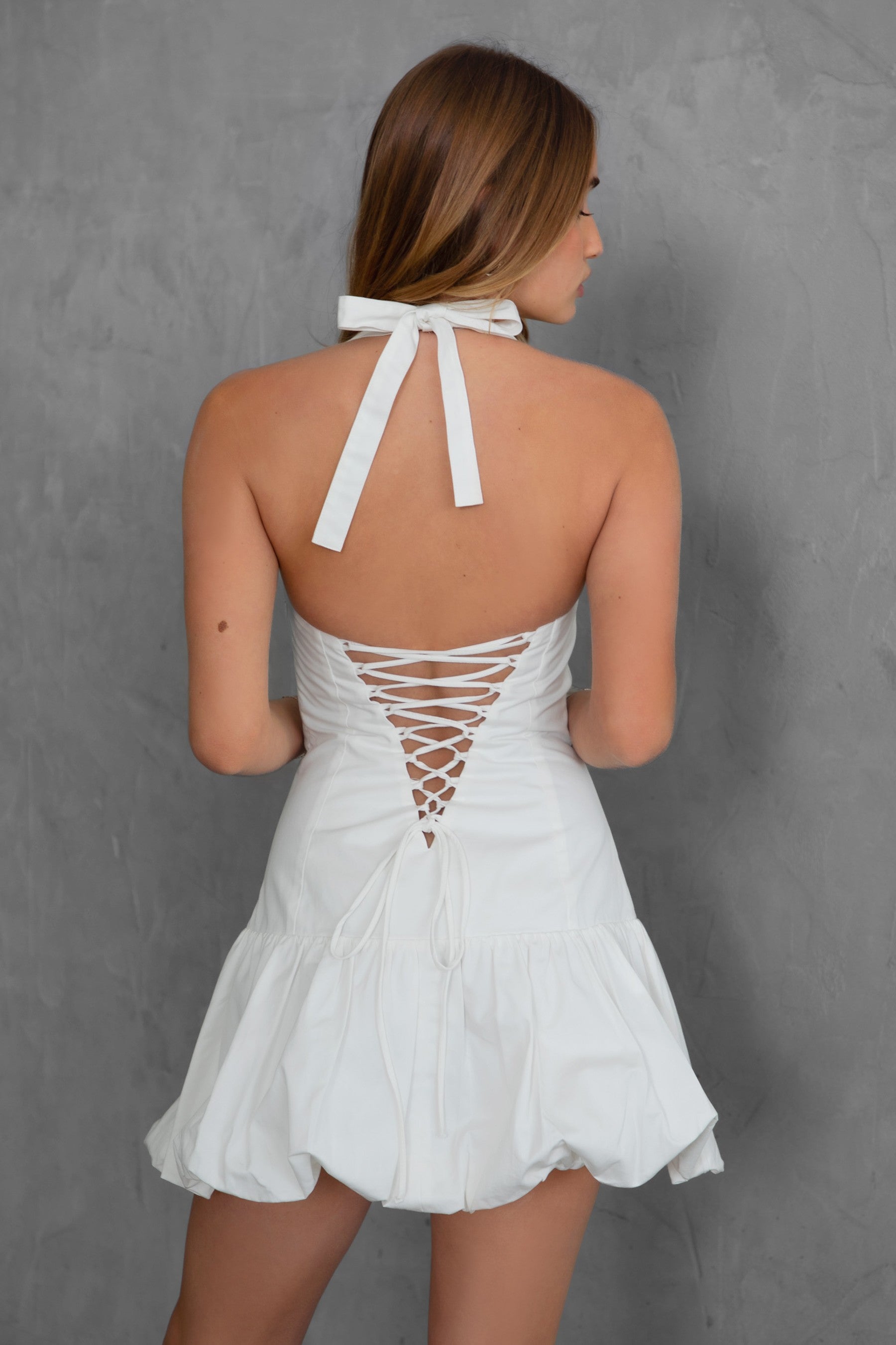 TIC TOC DH30936 DOLY Mini Dress featuring halter neckline, lace-up open back, and bubble hem in stretch twill fabric.