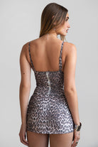 Model wearing the KITTIKITTI leopard mesh bustier top with V neckline and asymmetrical hem, styled with matching skirt for a bold night-out or festival look