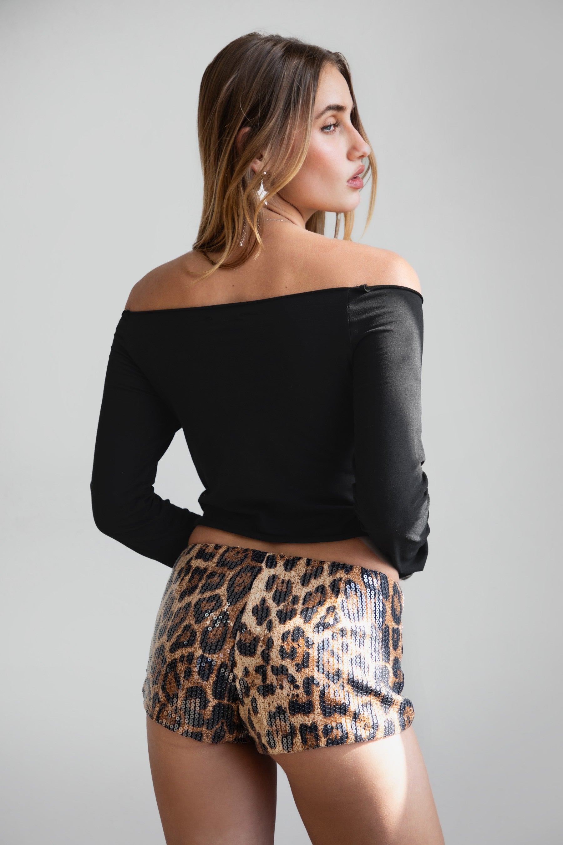 TIC TOC PH30980 CHEETAH Leopard Print Sequin Micro Shorts. Low-rise festival shorts with shimmering leopard print sequins and hidden side zipper.