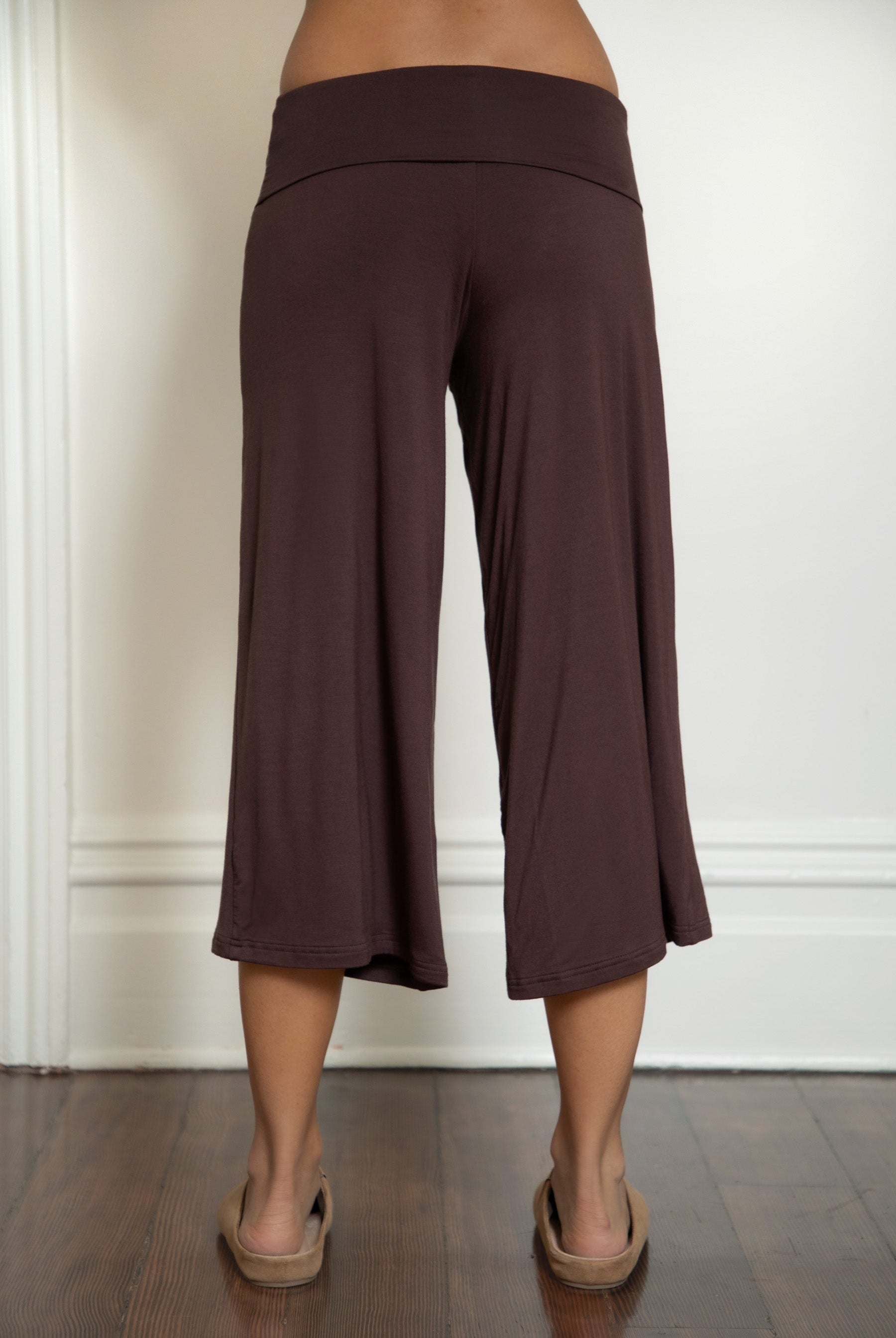 Woman wearing TIC TOC PH32000 SORA rayon spandex fold over low rise wide leg leggings featuring a soft lightweight jersey fabric, fold-over waistband, relaxed wide leg silhouette, and capri length, styled for a clean laid-back lounge and everyday look.