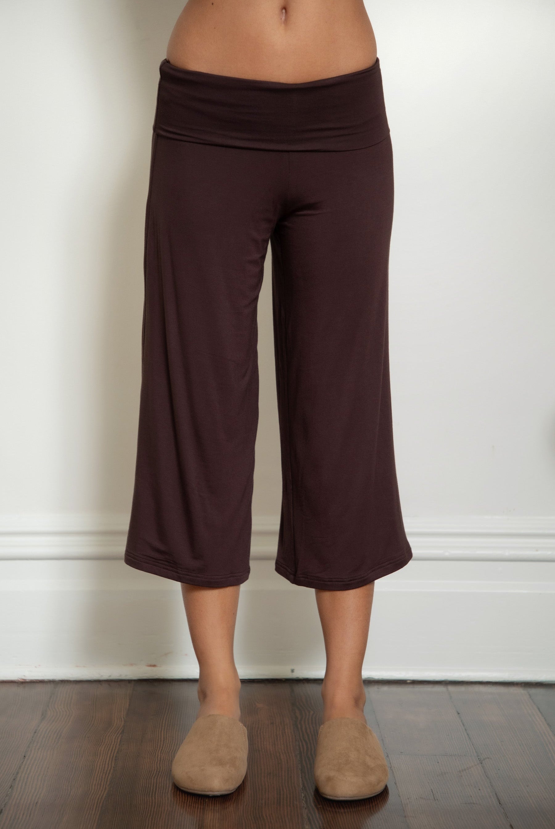 Woman wearing TIC TOC PH32000 SORA rayon spandex fold over low rise wide leg leggings featuring a soft lightweight jersey fabric, fold-over waistband, relaxed wide leg silhouette, and capri length, styled for a clean laid-back lounge and everyday look.