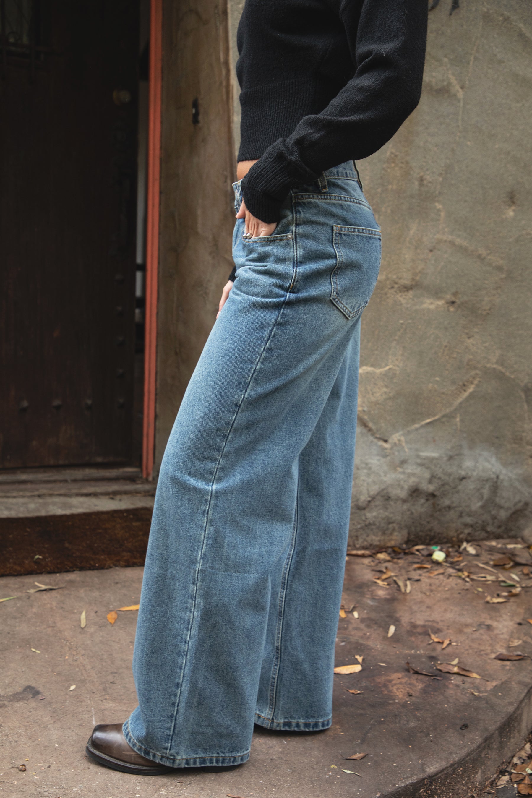 Woman wearing TIC TOC PJ31550-WINSLEY WINSLEY low rise straight leg denim jeans in a vintage blue wash with light fading, featuring a long straight wide leg silhouette, classic 5-pocket styling, belt loops, and a zipper fly button closure, styled casually with a fitted top for an everyday denim look.