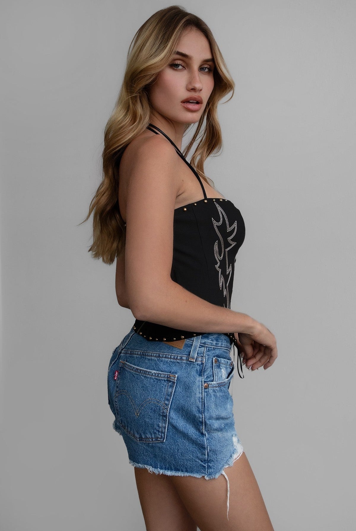 TIC TOC RAELYNN Embroidered Western Corset Top in black with halter tie, lace-up front, and studded detail for a bold western look.