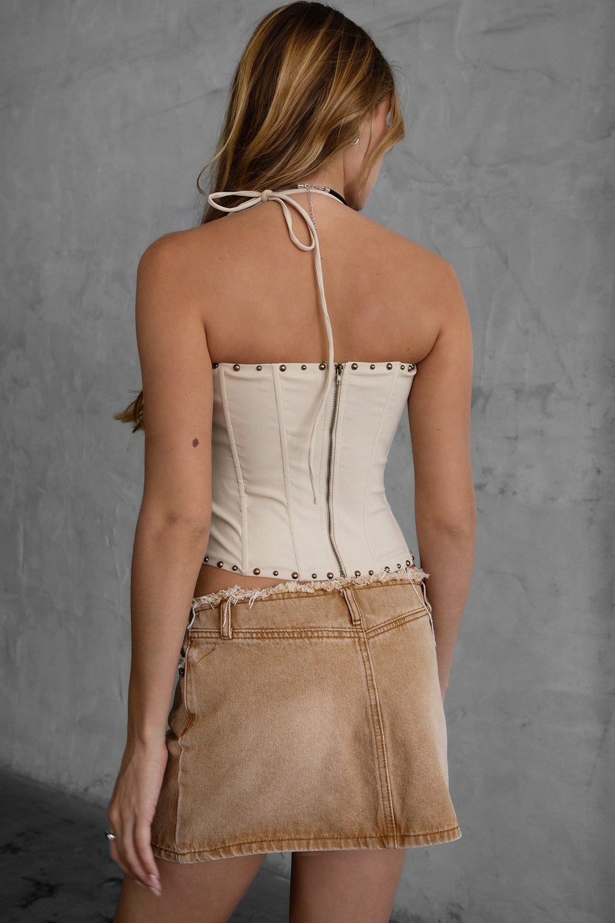TIC TOC RAELYNN Embroidered Western Corset Top in beige with halter tie, lace-up front, and studded detail for a bold western look.