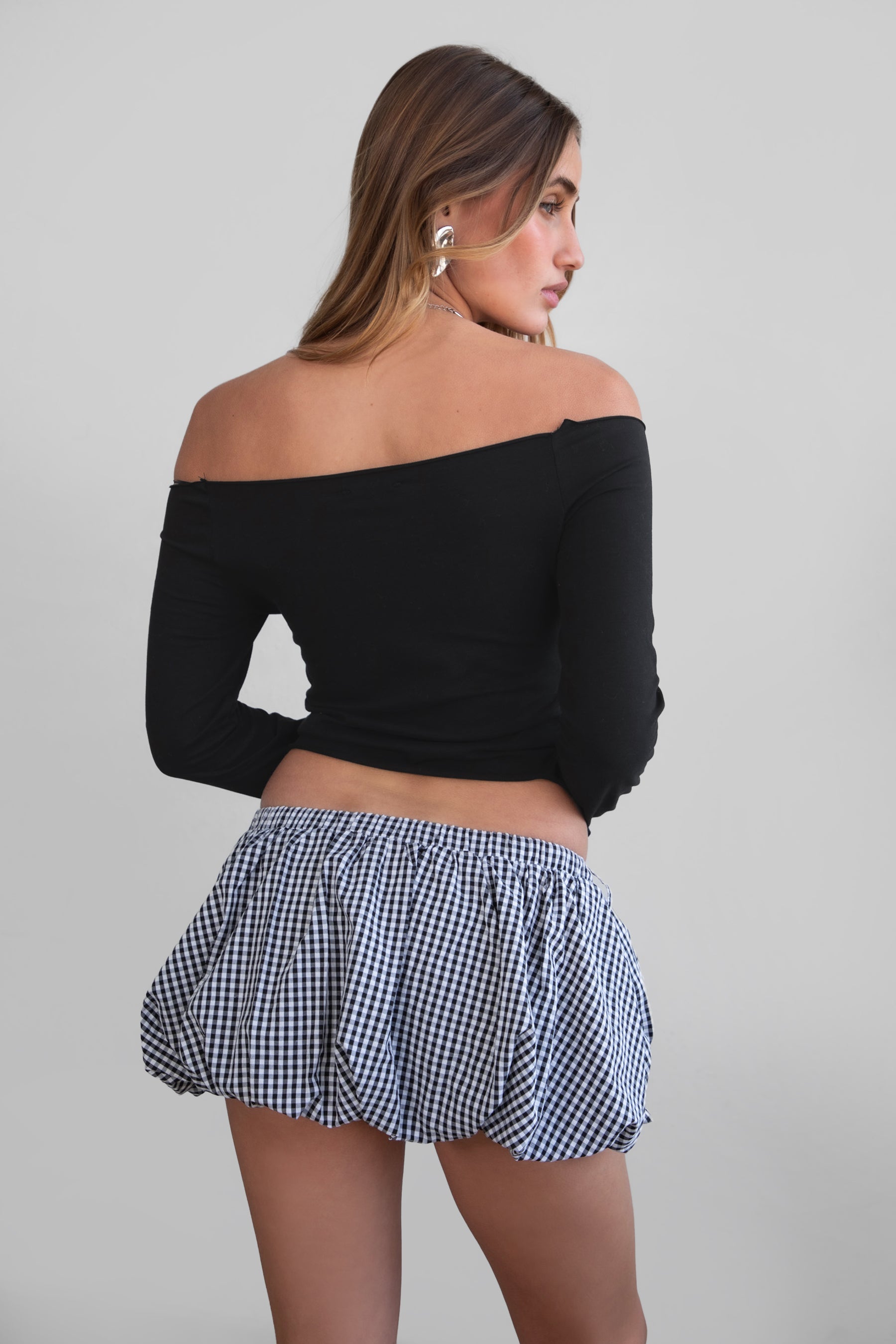 Woman wearing TIC TOC MSH30979-MADYEE ADYEE gingham bubble skirt with built-in shorts featuring a bubble hem silhouette, stretch elastic waistband, and easy pull-on fit for a playful western festival look.