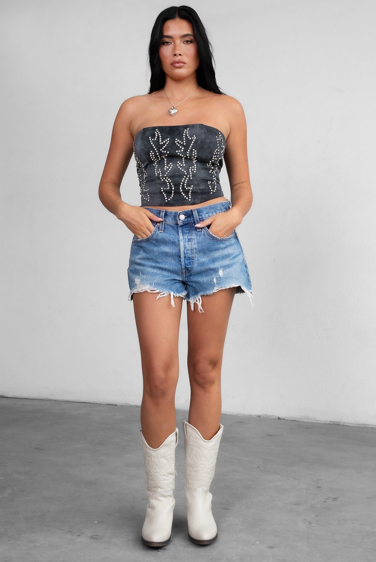 TIC TOC TA29069 BECKEE PU Vegan Leather Corset Top in distressed leather. Features a straight strapless neckline, rhinestone western detail, and lace-up back in color black.