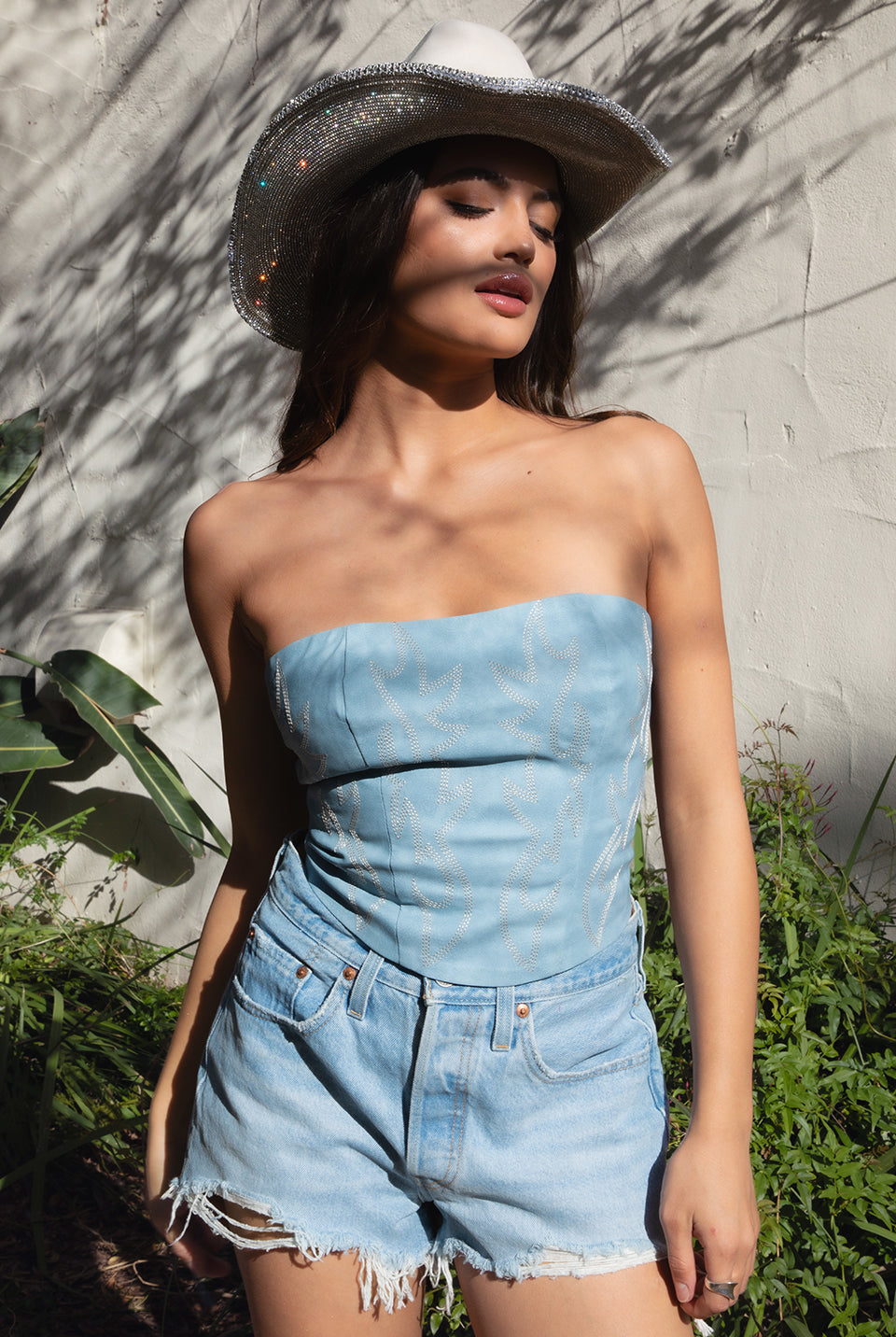 TIC TOC TA29069 BECKEE PU Vegan Leather Corset Top. Featuring embroidered western details, and an exposed lace up back. Perfect for bold, edgy, and Western-inspired looks.