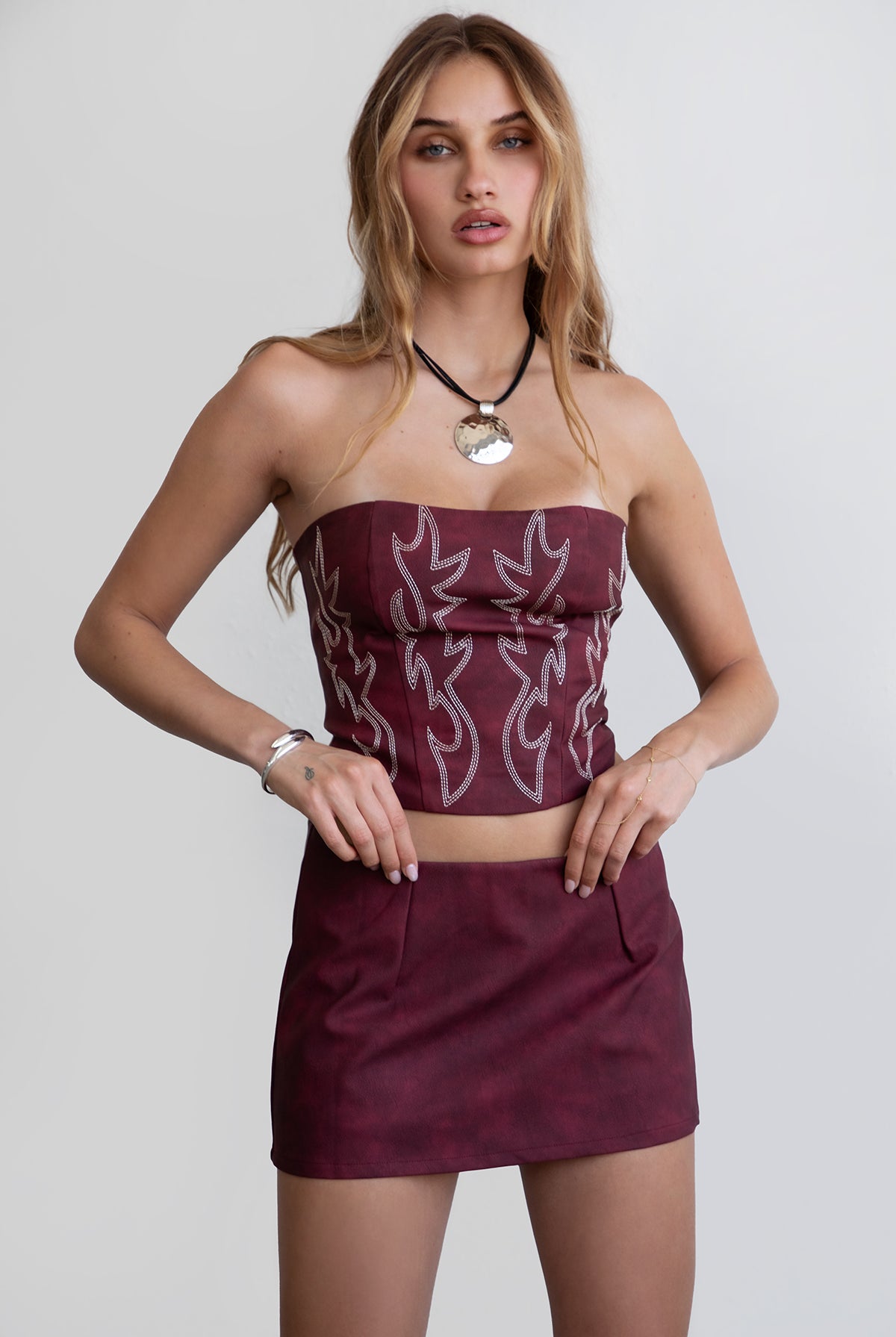 TIC TOC TA29069 BECKEE PU Vegan Leather Corset Top. Featuring embroidered western details, and an exposed lace up back. Perfect for bold, edgy, and Western-inspired looks.