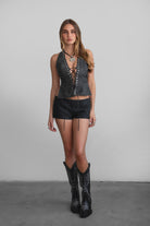 TIC TOC TA31106 LYLA Distressed Leather Studded Halter Top. Open torso lace-up design with studded details, perfect for festivals and Western-inspired outfits.