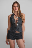 TIC TOC TA31106 LYLA Distressed Leather Studded Halter Top. Open torso lace-up design with studded details, perfect for festivals and Western-inspired outfits.