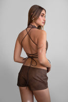 TIC TOC TA31106 LYLA Distressed Leather Studded Halter Top. Open torso lace-up design with studded details, perfect for festivals and Western-inspired outfits.