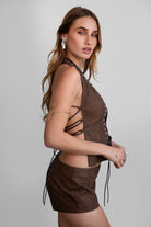 TIC TOC TA31106 LYLA Distressed Leather Studded Halter Top. Open torso lace-up design with studded details, perfect for festivals and Western-inspired outfits.