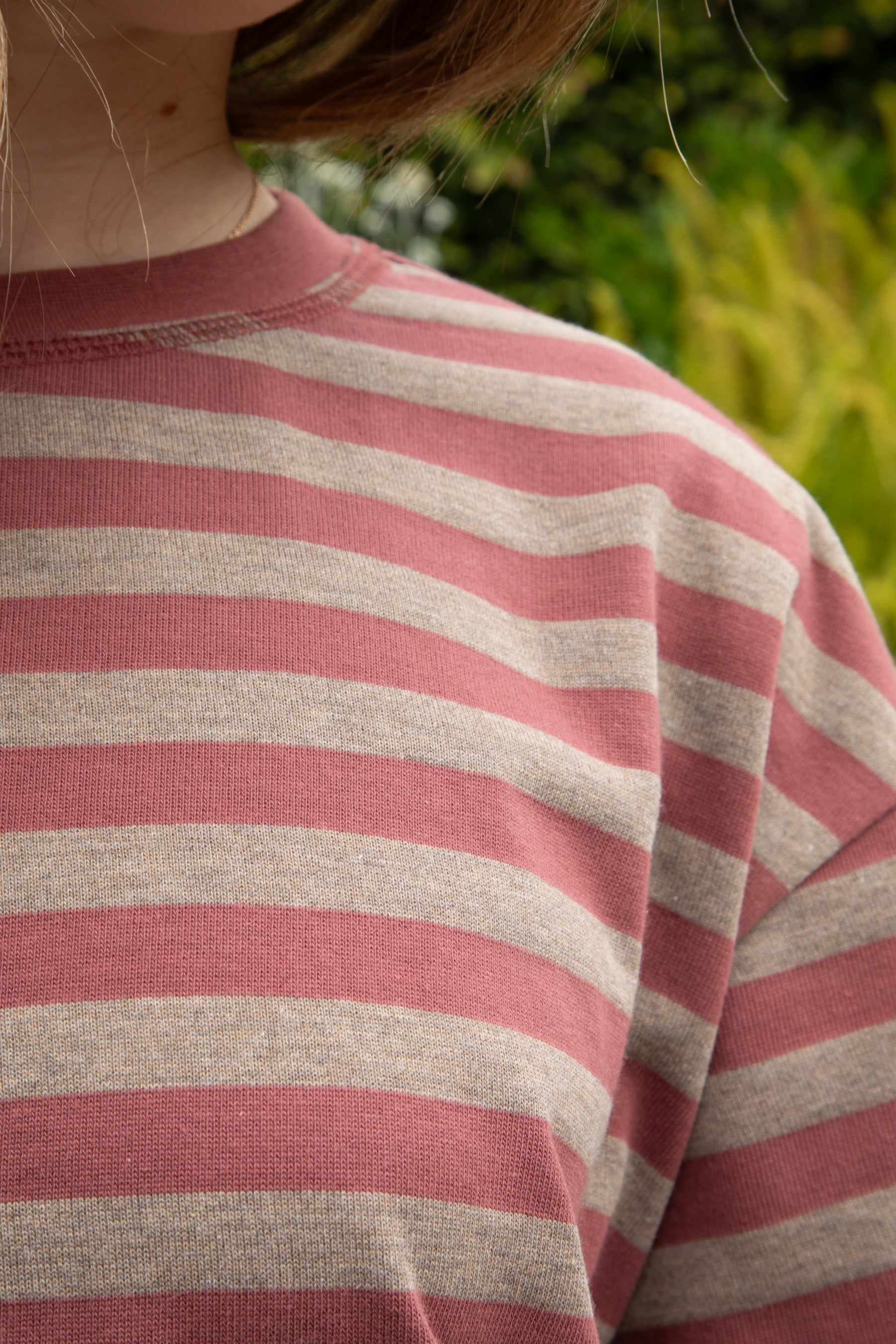 Woman wearing MARIN classic crewneck oversized striped short sleeve top featuring a timeless crew neckline, relaxed oversized fit, drop shoulder sleeves, soft horizontal stripe pattern, breathable 100% cotton fabric, and clean straight hem for everyday casual styling.