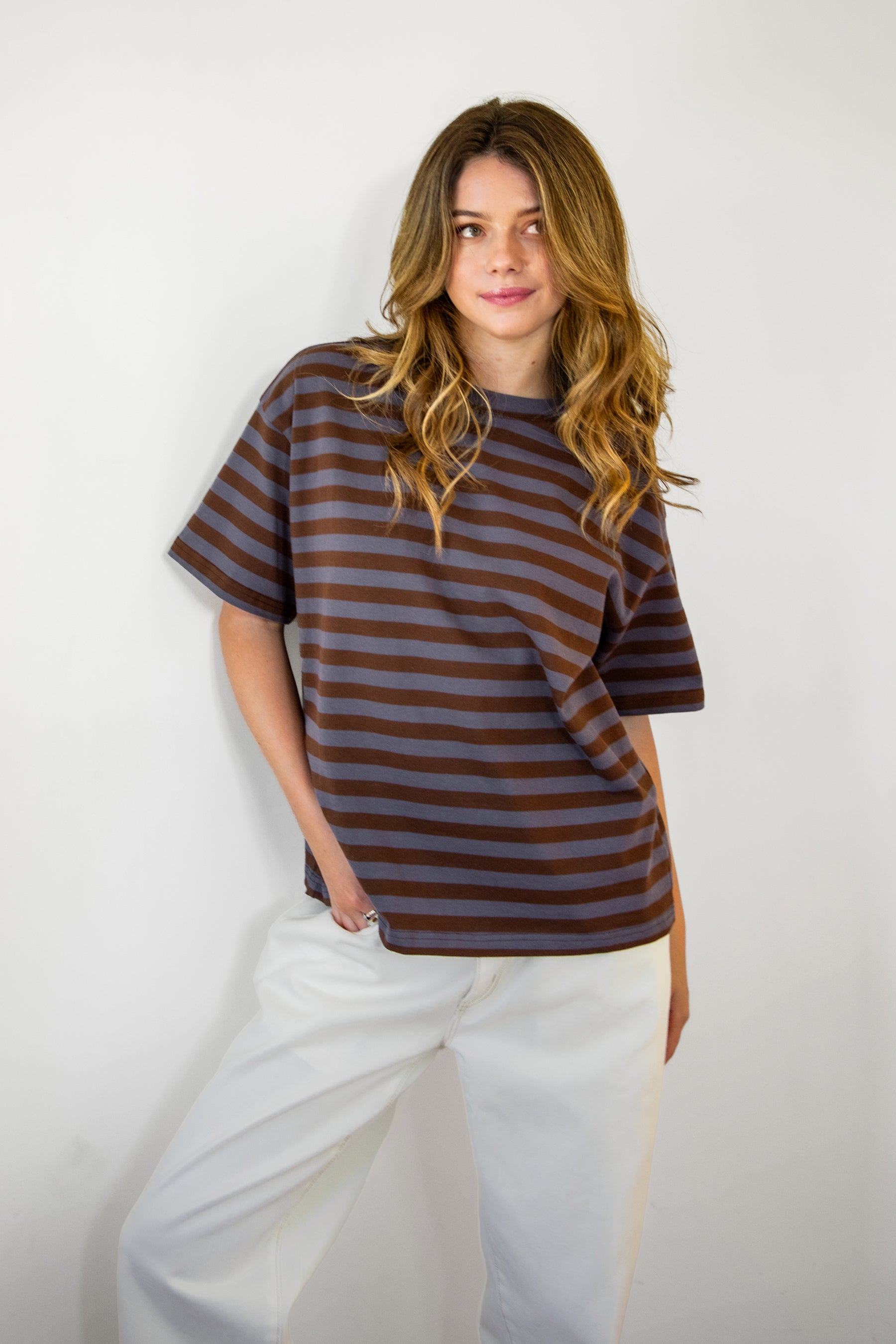 Woman wearing MARIN classic crewneck oversized striped short sleeve top featuring a timeless crew neckline, relaxed oversized fit, drop shoulder sleeves, soft horizontal stripe pattern, breathable 100% cotton fabric, and clean straight hem for everyday casual styling.