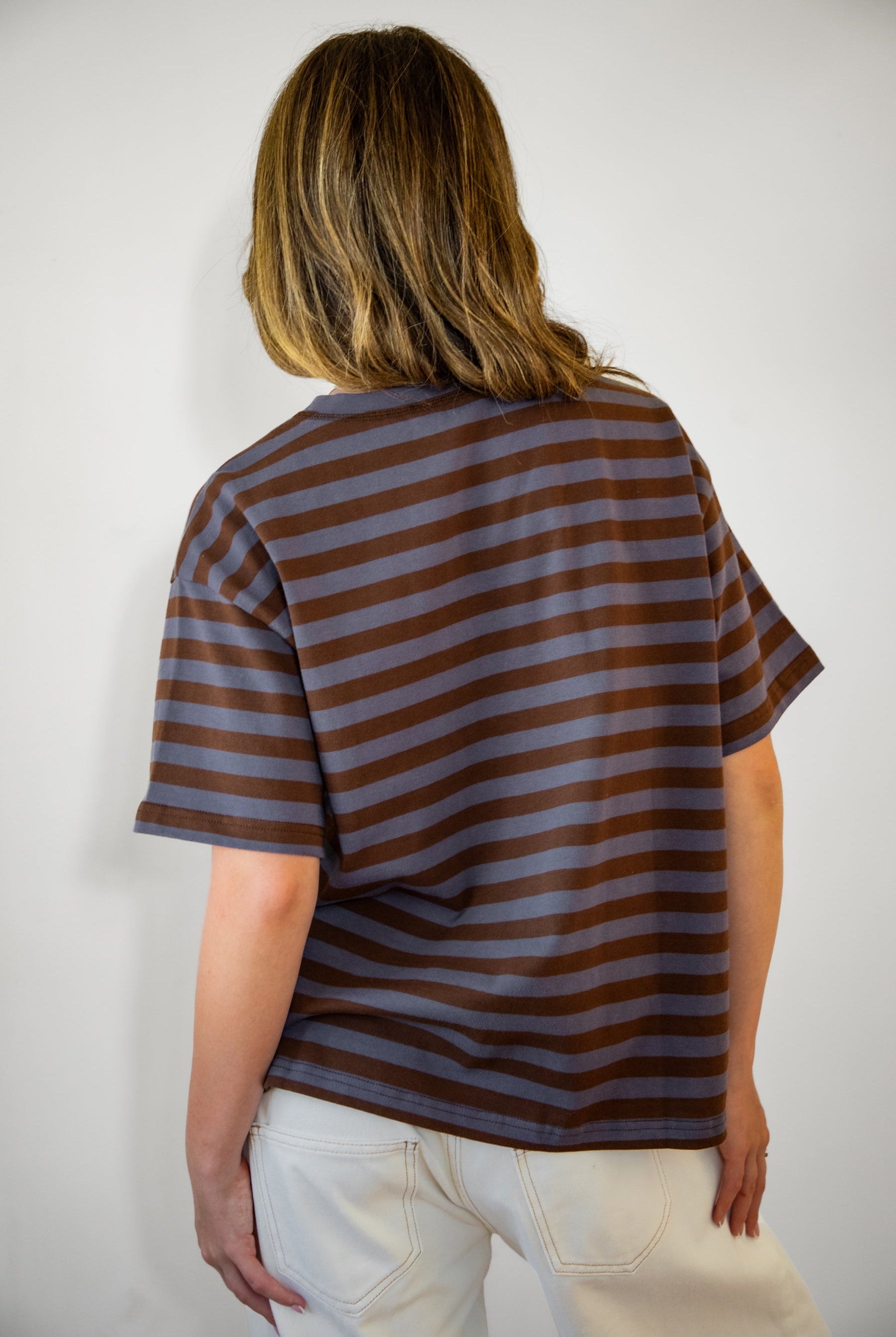 Woman wearing MARIN classic crewneck oversized striped short sleeve top featuring a timeless crew neckline, relaxed oversized fit, drop shoulder sleeves, soft horizontal stripe pattern, breathable 100% cotton fabric, and clean straight hem for everyday casual styling.