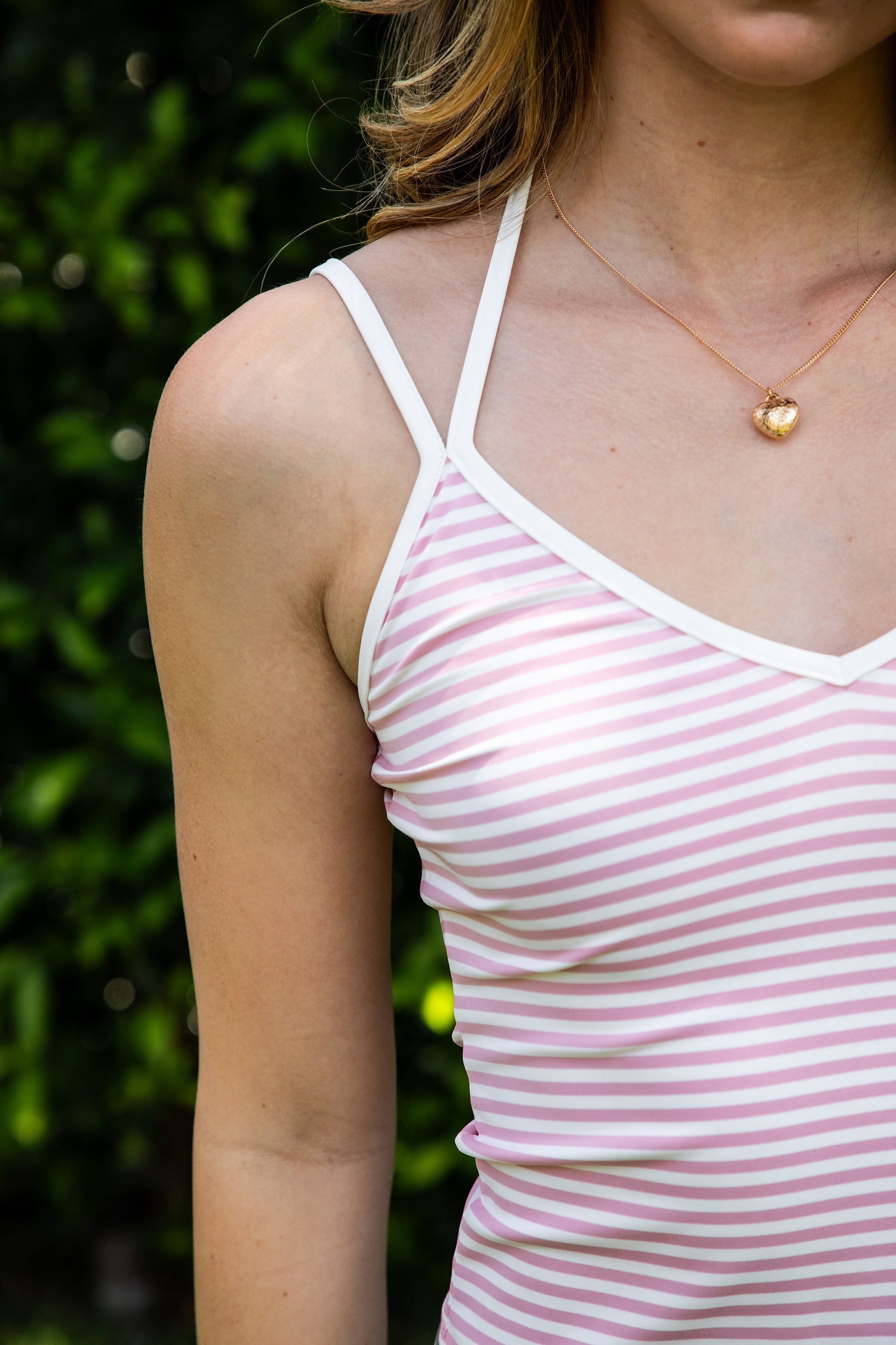 Woman wearing SAYLOR stripe double strap tank top featuring a V-neckline with contrast trim, double adjustable shoulder straps, mid length fitted silhouette, stripe stretch jersey fabric, and soft lightweight construction for casual lounge and athleisure styling.