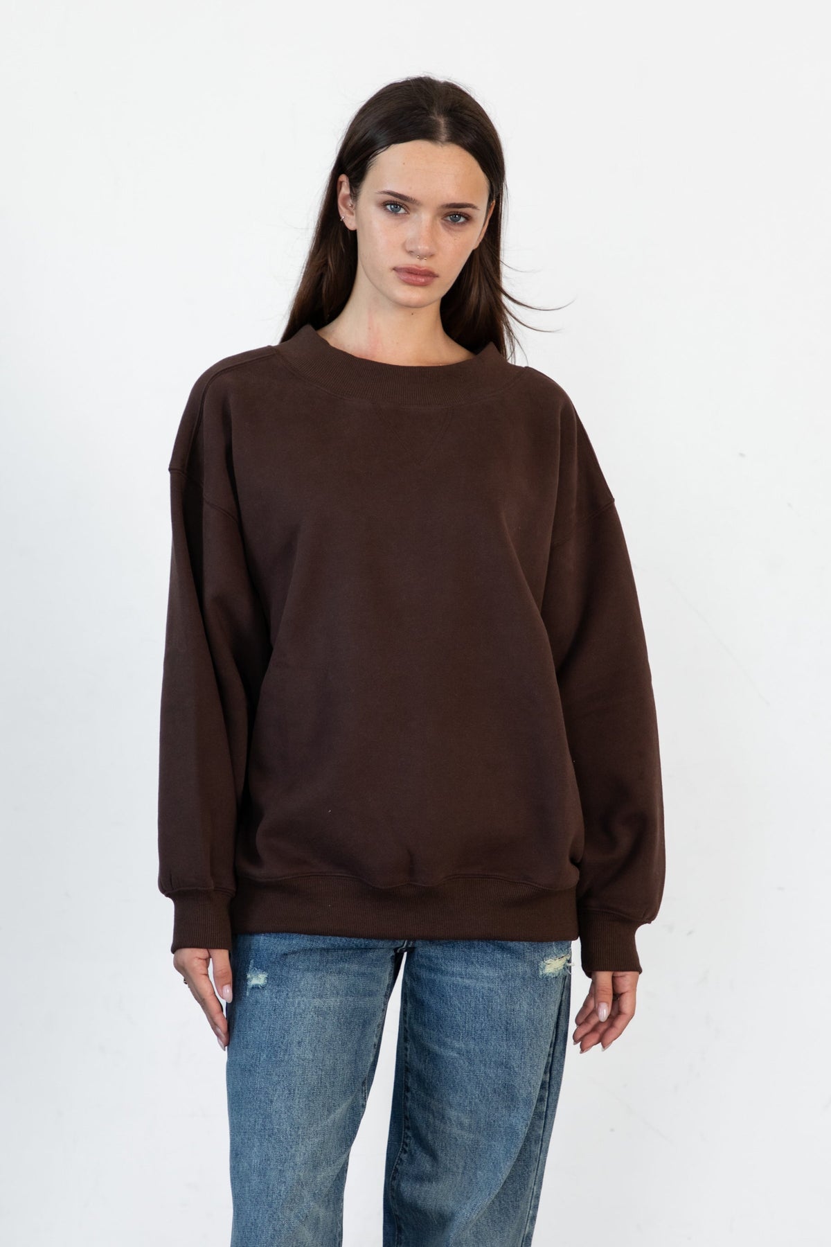 Woman wearing LANI mock neck cloud fleece sweatshirt featuring soft cotton blend cloud fleece fabric, ribbed mock neckline, relaxed oversized fit, dropped shoulder design, long sleeves with ribbed cuffs, triangle stitch detail at center front, and ribbed hem for a cozy comfortable finish.