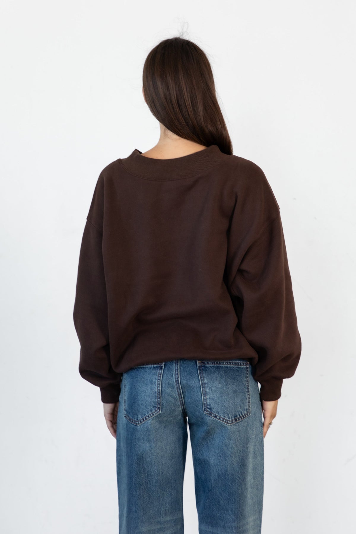 Woman wearing LANI mock neck cloud fleece sweatshirt featuring soft cotton blend cloud fleece fabric, ribbed mock neckline, relaxed oversized fit, dropped shoulder design, long sleeves with ribbed cuffs, triangle stitch detail at center front, and ribbed hem for a cozy comfortable finish.