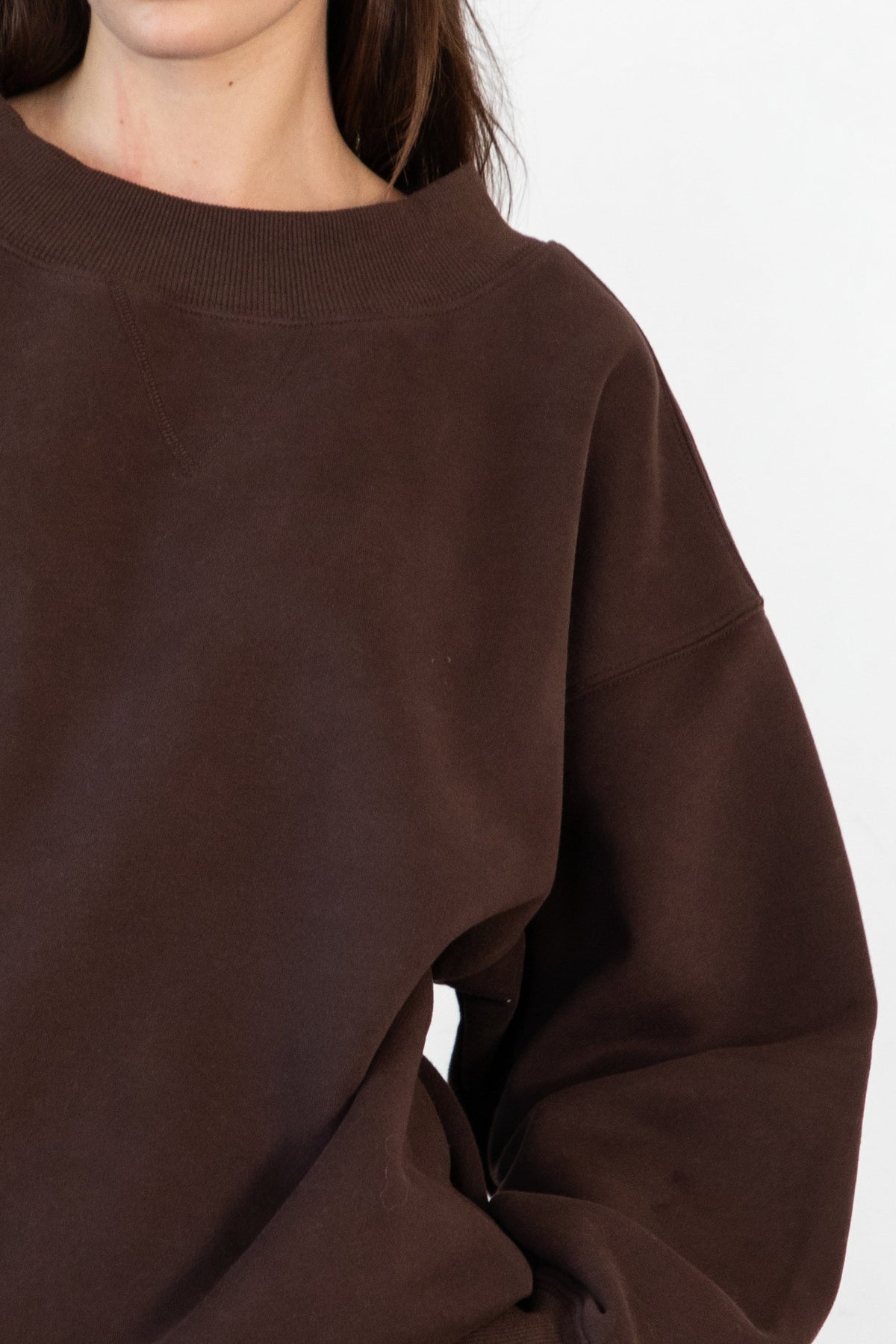 Woman wearing LANI mock neck cloud fleece sweatshirt featuring soft cotton blend cloud fleece fabric, ribbed mock neckline, relaxed oversized fit, dropped shoulder design, long sleeves with ribbed cuffs, triangle stitch detail at center front, and ribbed hem for a cozy comfortable finish.