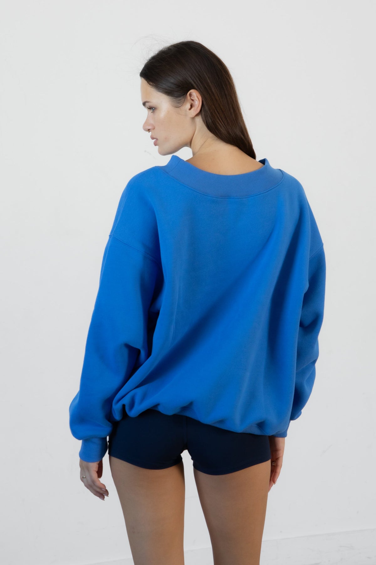 Woman wearing LANI mock neck cloud fleece sweatshirt featuring soft cotton blend cloud fleece fabric, ribbed mock neckline, relaxed oversized fit, dropped shoulder design, long sleeves with ribbed cuffs, triangle stitch detail at center front, and ribbed hem for a cozy comfortable finish.