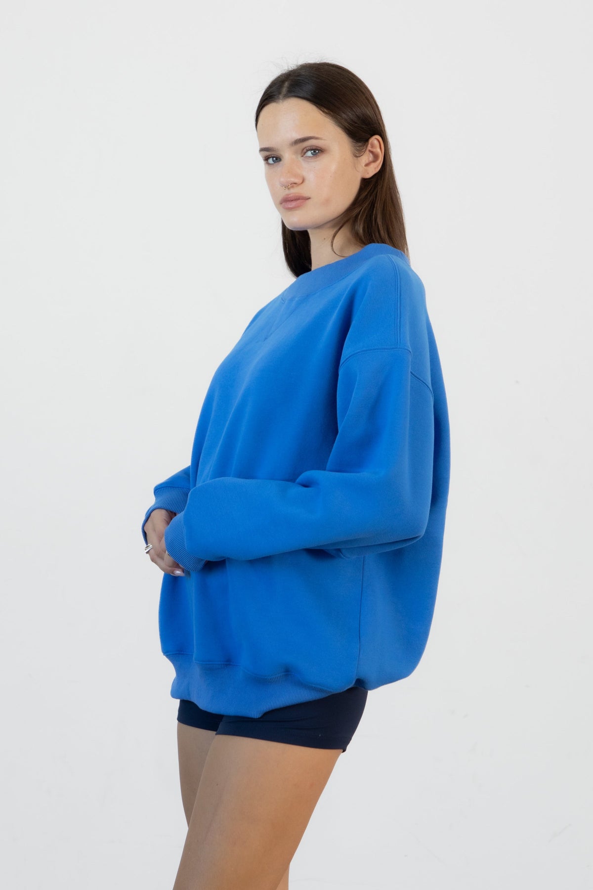 Woman wearing LANI mock neck cloud fleece sweatshirt featuring soft cotton blend cloud fleece fabric, ribbed mock neckline, relaxed oversized fit, dropped shoulder design, long sleeves with ribbed cuffs, triangle stitch detail at center front, and ribbed hem for a cozy comfortable finish.