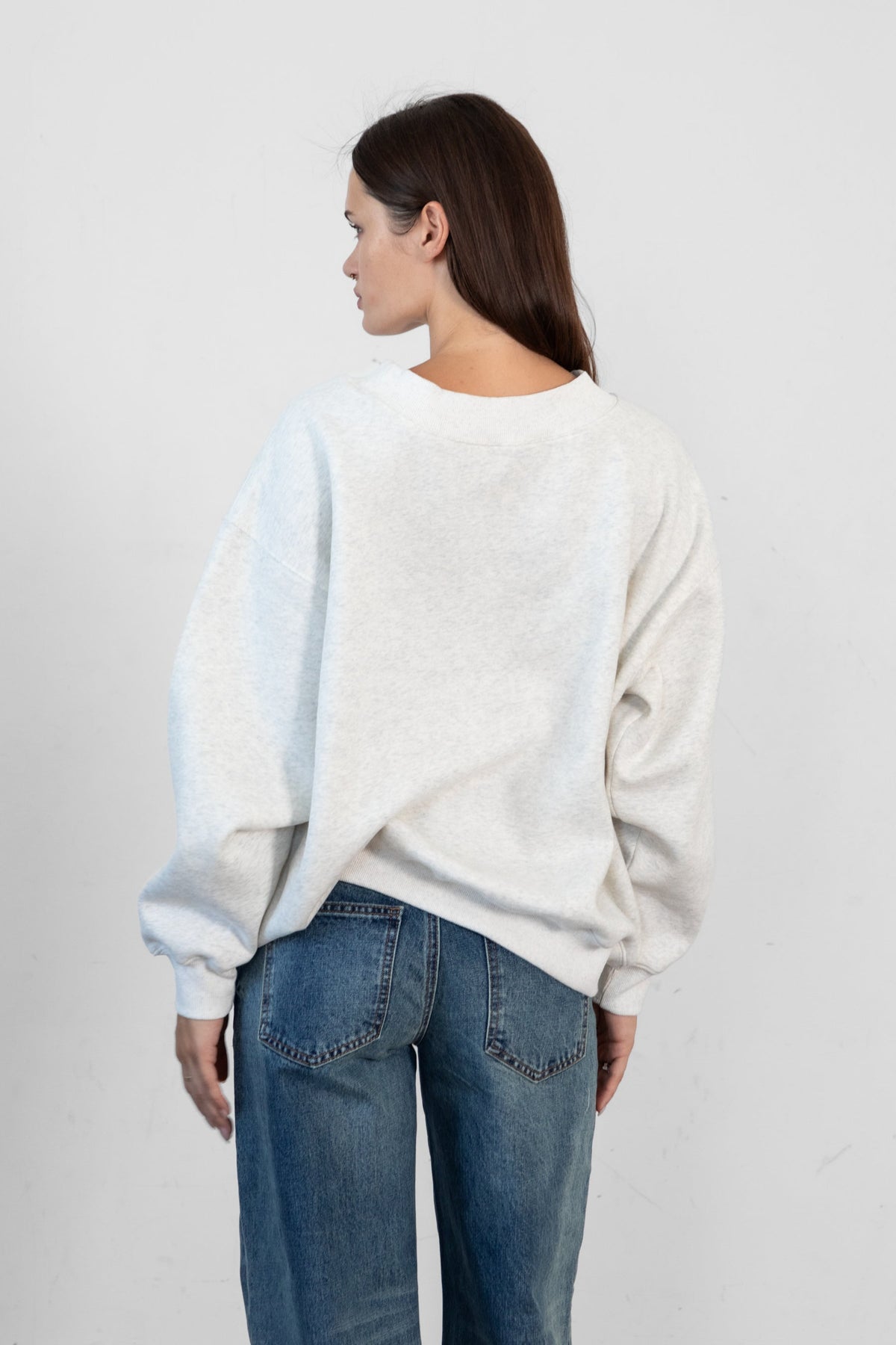 Woman wearing LANI mock neck cloud fleece sweatshirt featuring soft cotton blend cloud fleece fabric, ribbed mock neckline, relaxed oversized fit, dropped shoulder design, long sleeves with ribbed cuffs, triangle stitch detail at center front, and ribbed hem for a cozy comfortable finish.