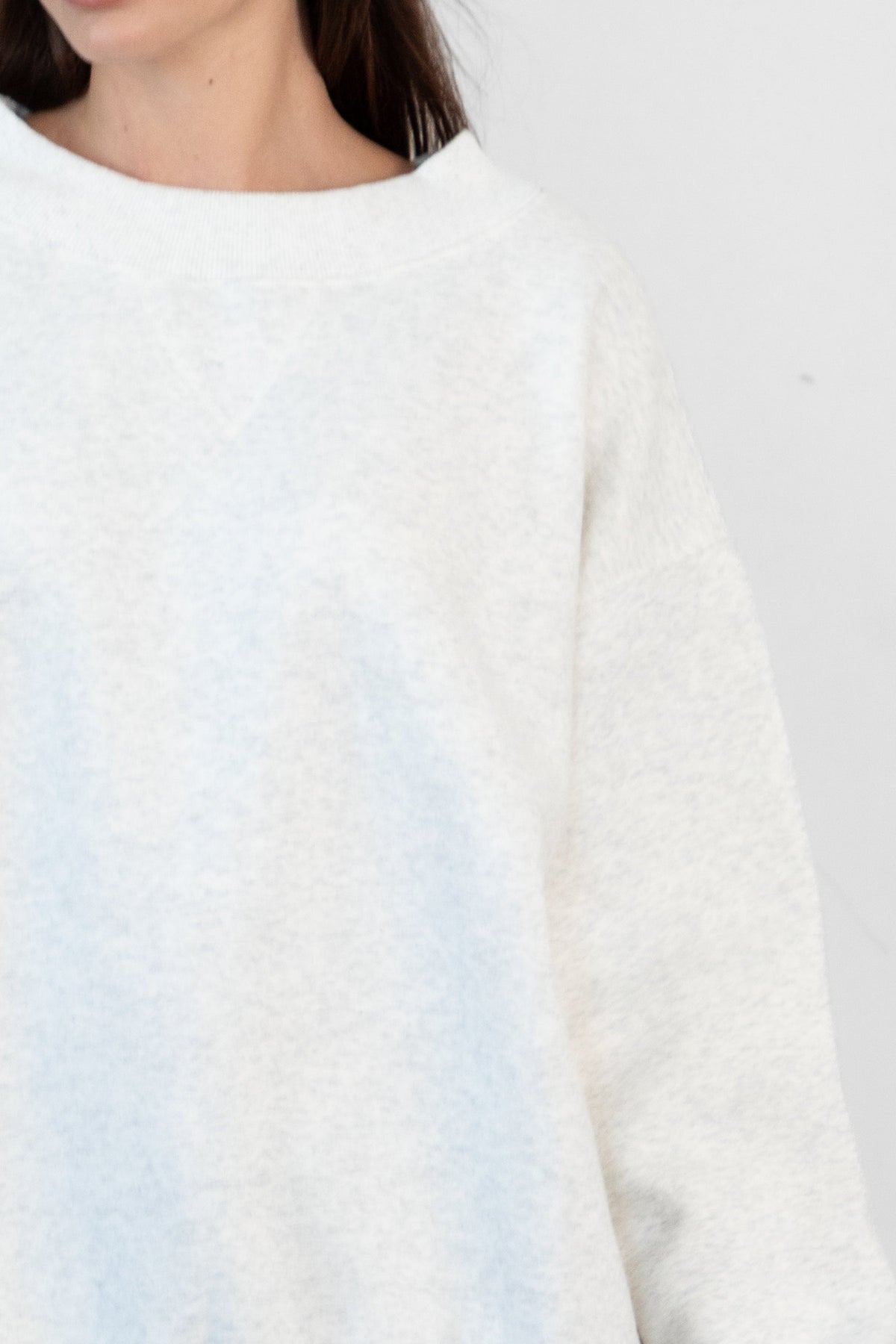 Woman wearing LANI mock neck cloud fleece sweatshirt featuring soft cotton blend cloud fleece fabric, ribbed mock neckline, relaxed oversized fit, dropped shoulder design, long sleeves with ribbed cuffs, triangle stitch detail at center front, and ribbed hem for a cozy comfortable finish.