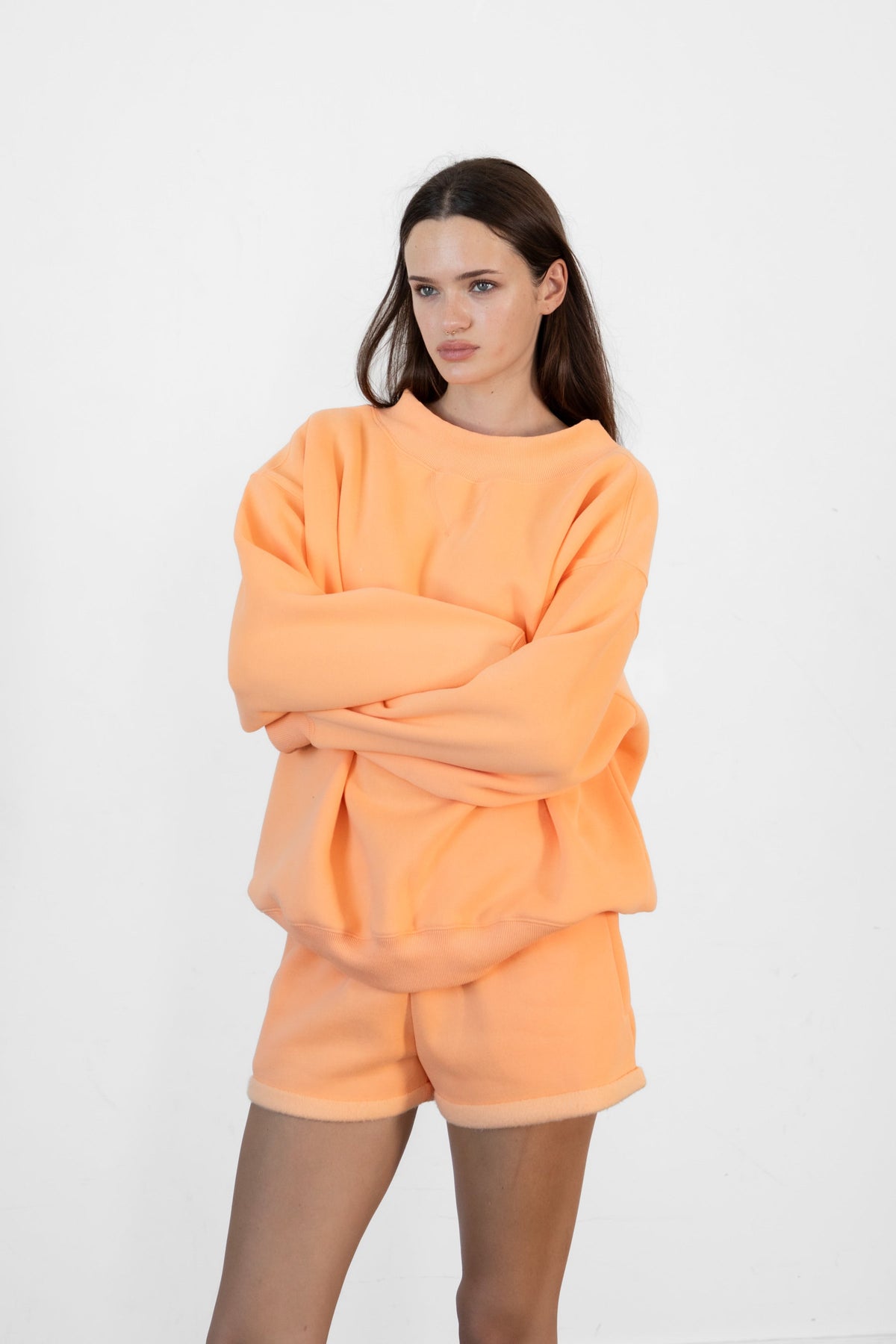Woman wearing LANI mock neck cloud fleece sweatshirt featuring soft cotton blend cloud fleece fabric, ribbed mock neckline, relaxed oversized fit, dropped shoulder design, long sleeves with ribbed cuffs, triangle stitch detail at center front, and ribbed hem for a cozy comfortable finish.