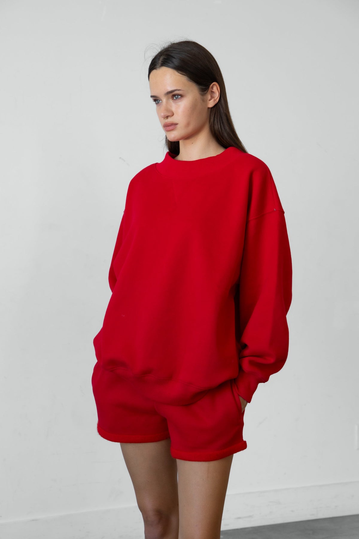 Woman wearing LANI mock neck cloud fleece sweatshirt featuring soft cotton blend cloud fleece fabric, ribbed mock neckline, relaxed oversized fit, dropped shoulder design, long sleeves with ribbed cuffs, triangle stitch detail at center front, and ribbed hem for a cozy comfortable finish.