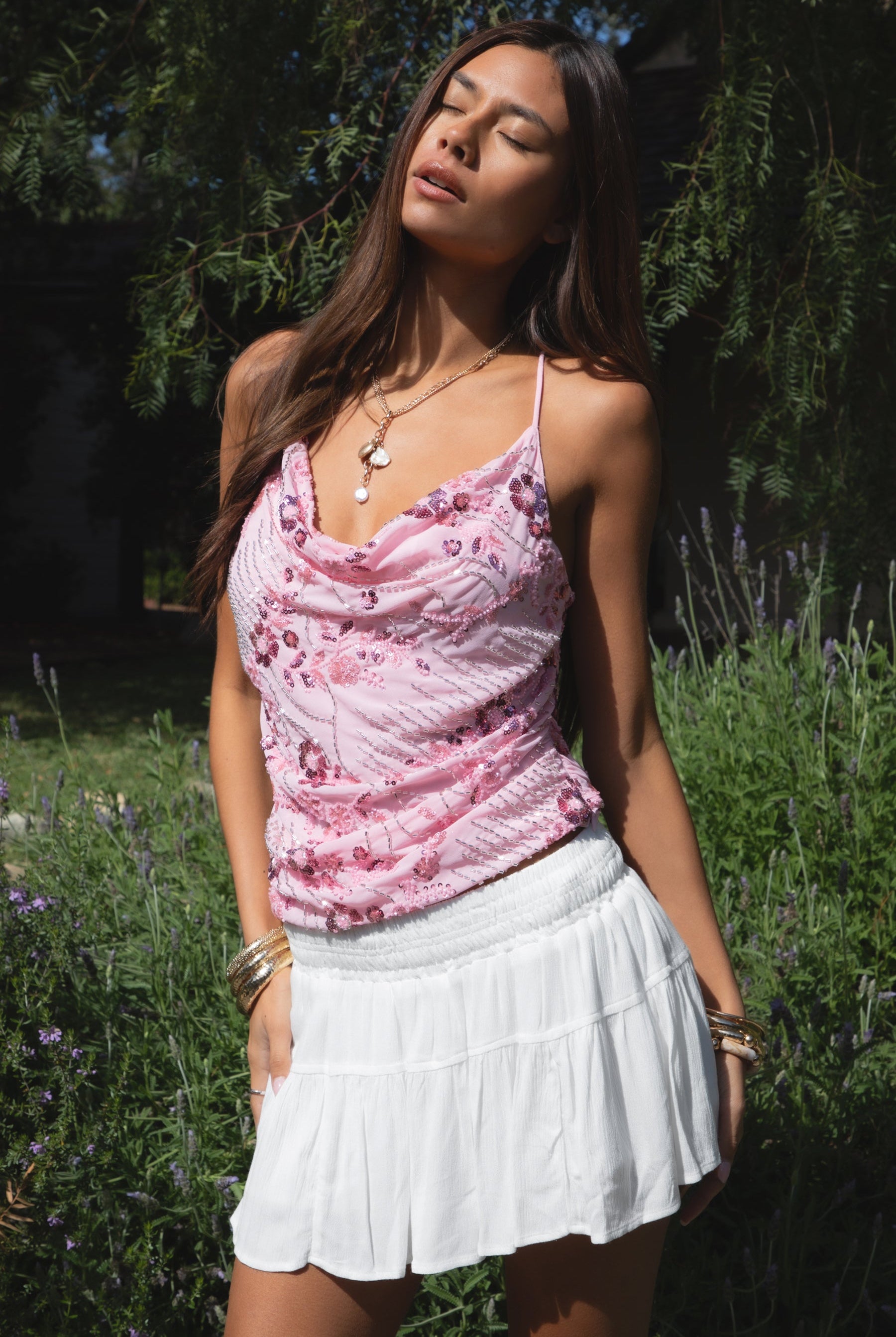 Woman wearing TIC TOC TL31684 AURYA chiffon sequin beaded cowl neck top featuring a draped cowl neckline, floral sequin and beaded embroidery, thin adjustable straps with cross back detail, fitted cropped silhouette, and asymmetrical hemline for a feminine festival and night-out look.