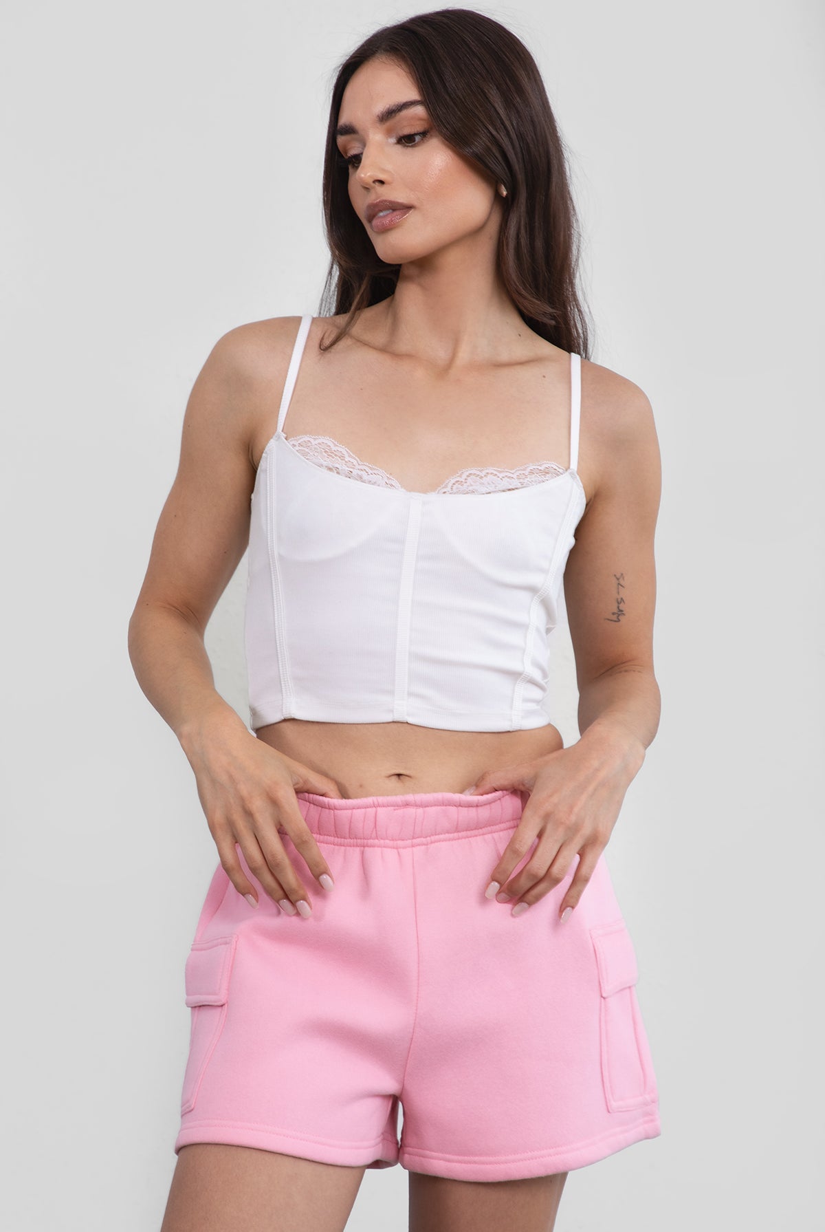 Pink mid-rise fleece shorts featuring an elastic waistband and cargo-style pockets by Tic Toc.