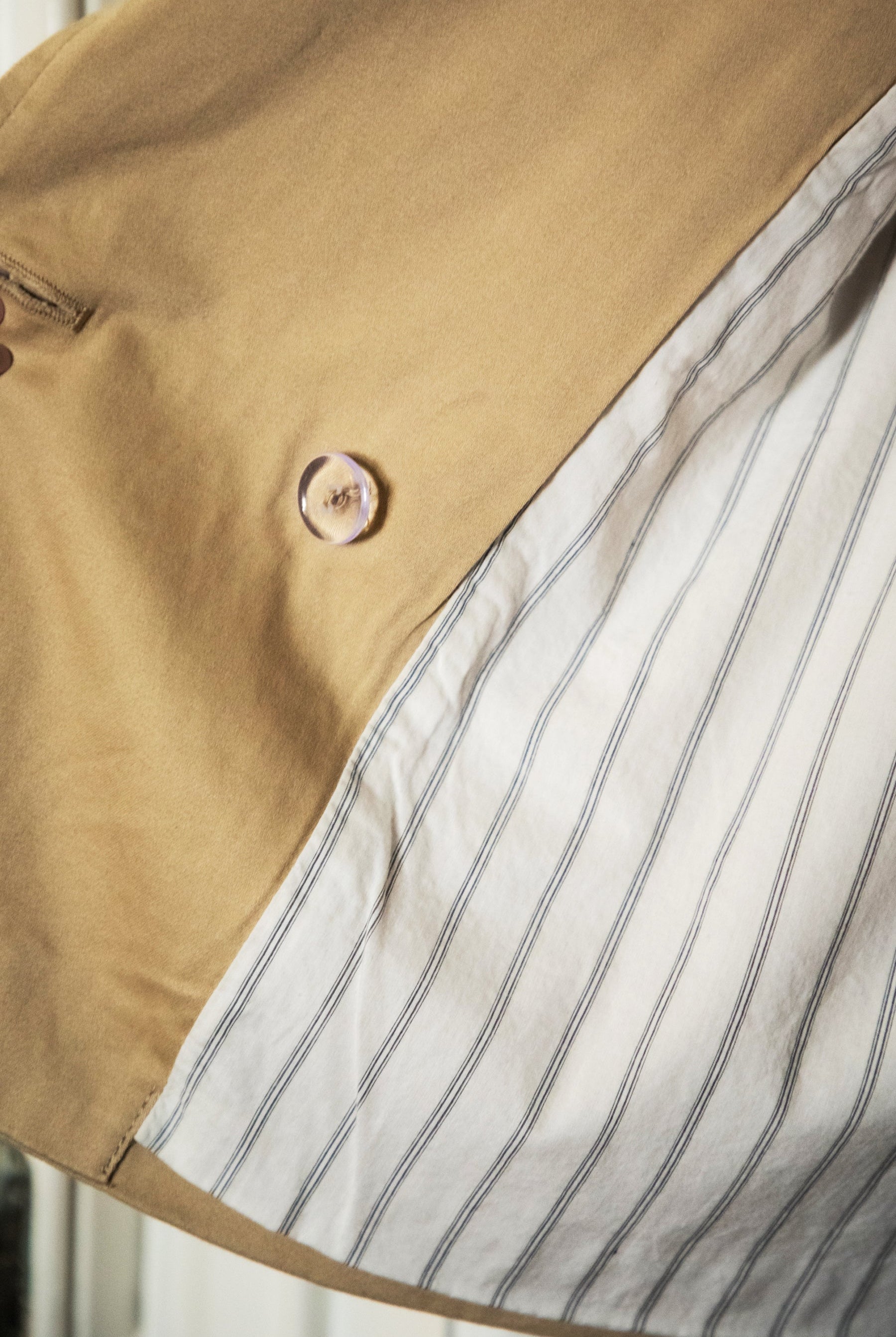 Woman wearing TIC TOC TT31828-MARAIS MARAIS oversized long sleeve cropped trench jacket featuring a double breasted front button closure, drop shoulder long sleeves with adjustable sleeve straps, removable thick self tie waist strap, and two loop holes on the back, finished with stripe voile lining inside, styled over a simple top and tailored bottoms for a Parisian chic, western-minimal layered look.