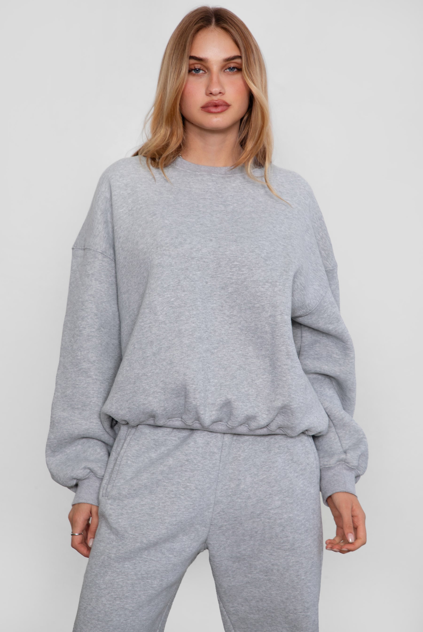 Relaxed fit fleece sweater for women with dropped shoulders and plush cozy fabric in heather grey