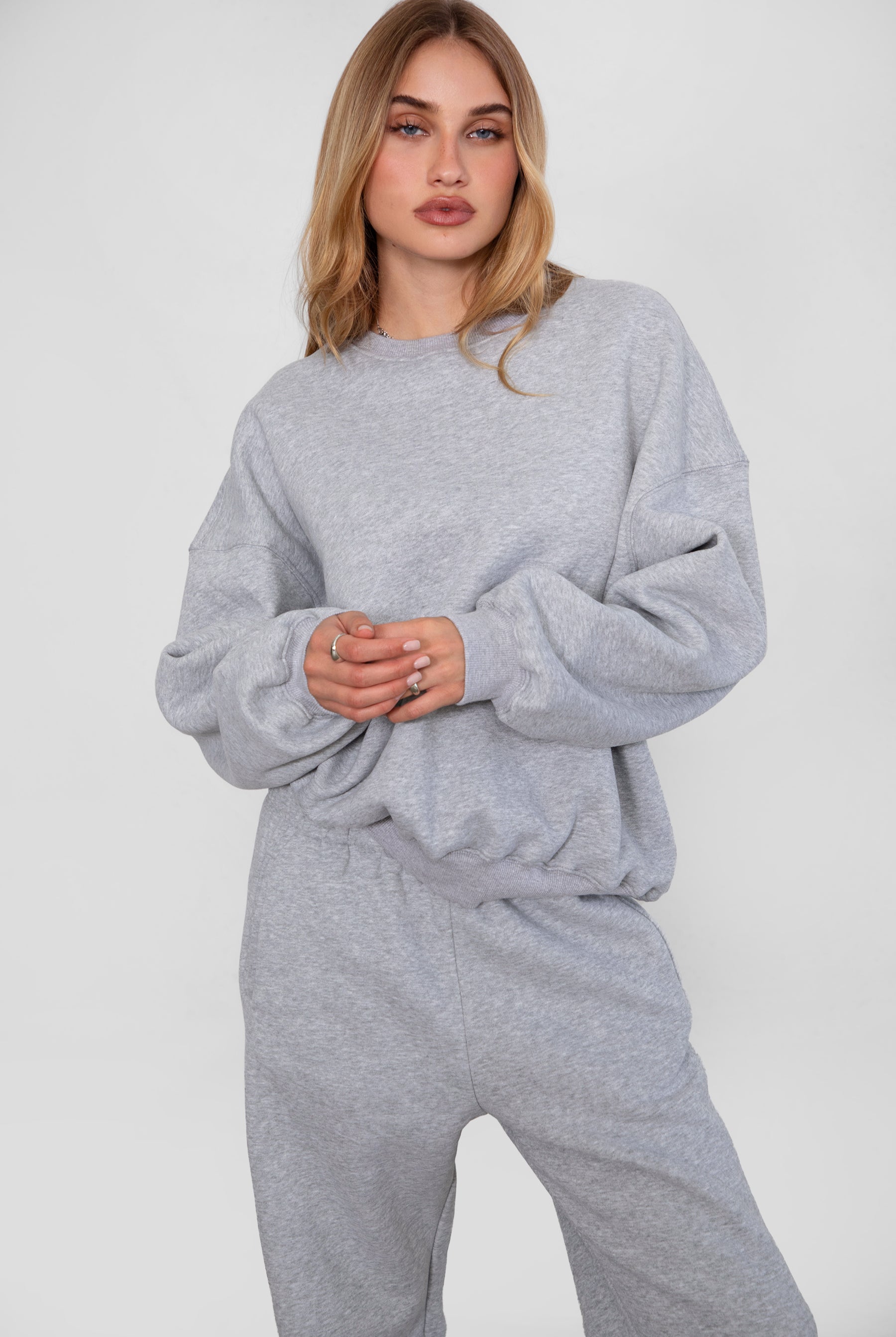Relaxed fit fleece sweater for women with dropped shoulders and plush cozy fabric in heather grey