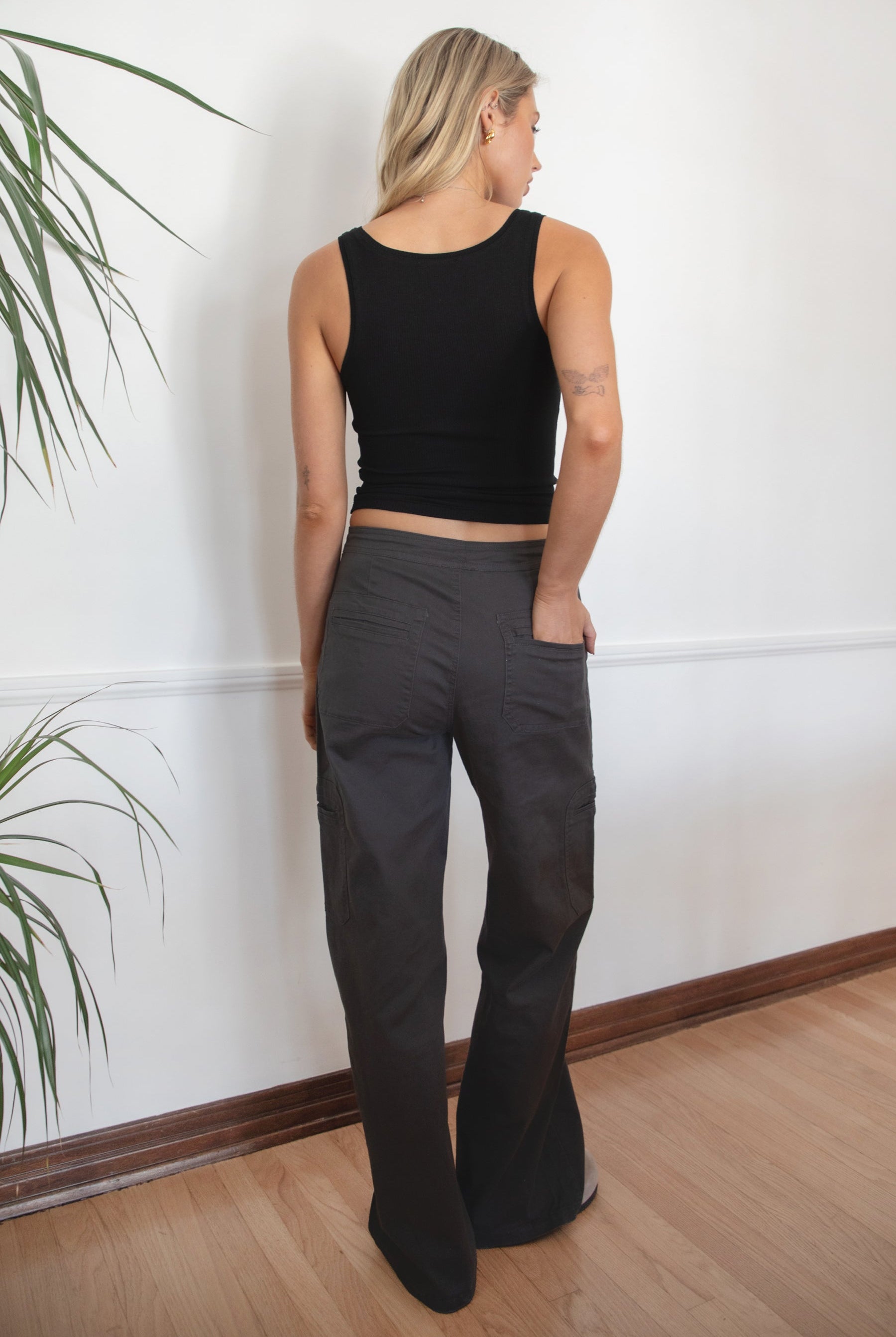 Woman wearing a black tank top and TIC TOC PH29257 ARROW charcoal twill carpenter cargo pants featuring multiple utility pockets and straight-leg fit.