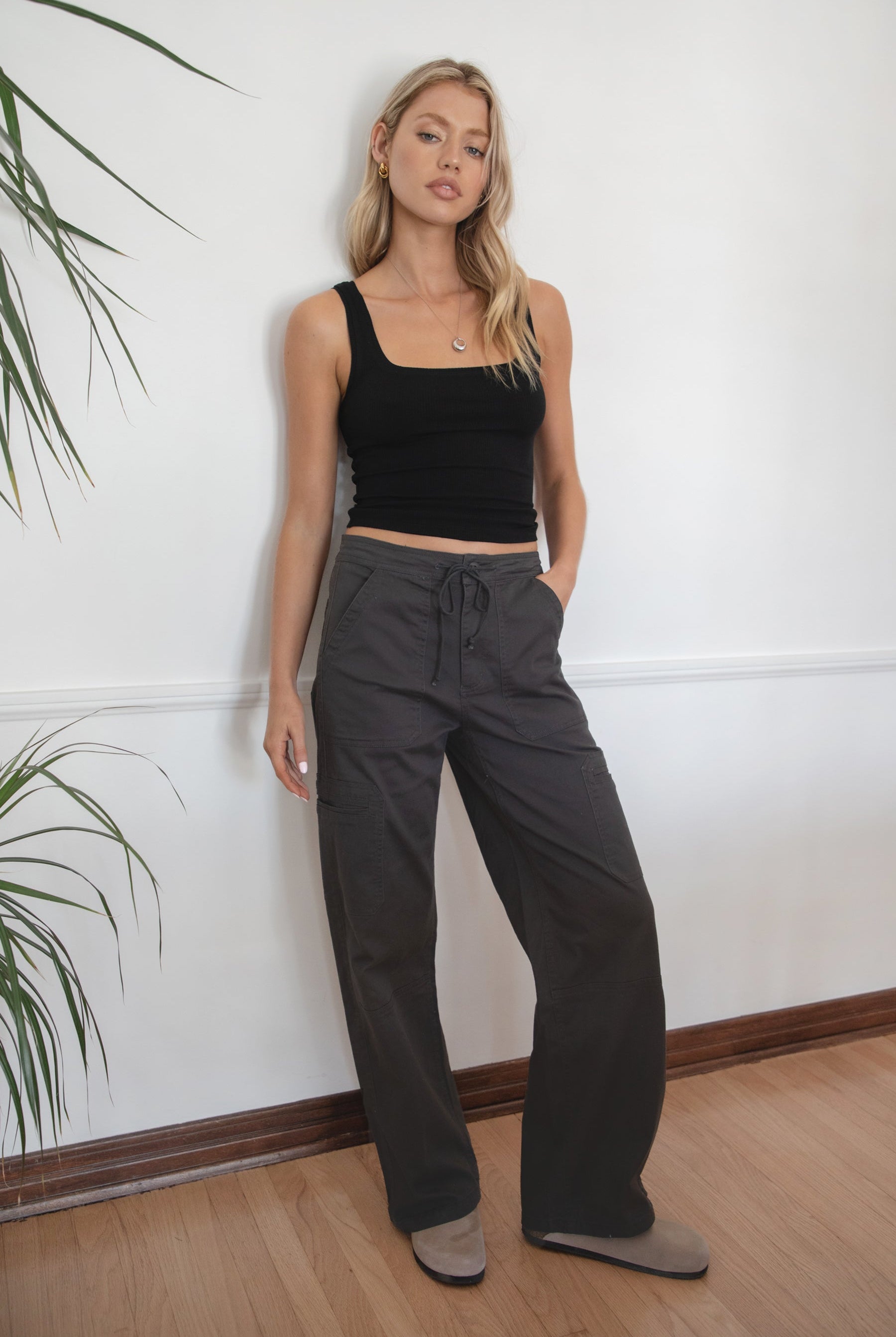 Woman wearing a black tank top and TIC TOC PH29257 ARROW charcoal twill carpenter cargo pants featuring multiple utility pockets and straight-leg fit.