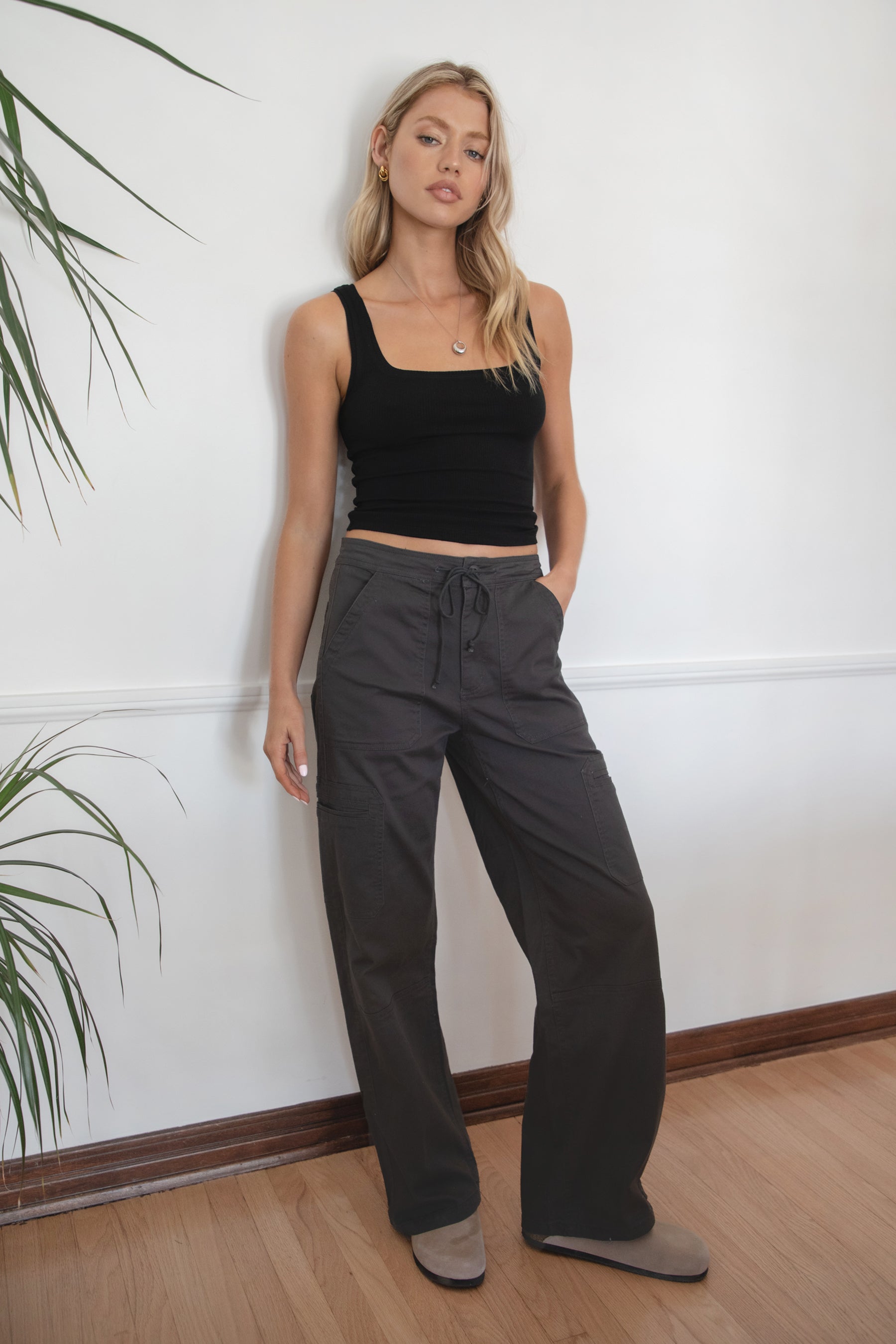 Woman wearing a black tank top and TIC TOC PH29257 ARROW charcoal twill carpenter cargo pants featuring multiple utility pockets and straight-leg fit.