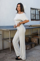 Woman wearing the TIC TOC PH31588BA SORA heather white fold over straight leg leggings featuring a low rise waistline, smooth stretch fabric, and straight leg finish with the matching top outdoors.