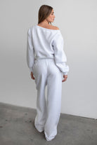 Woman wearing the TIC TOC PJ30241 LANI ash cloud fleece wide leg sweatpants featuring a straight leg silhouette, drawcord waistband, and side pockets paired with a matching sweater.