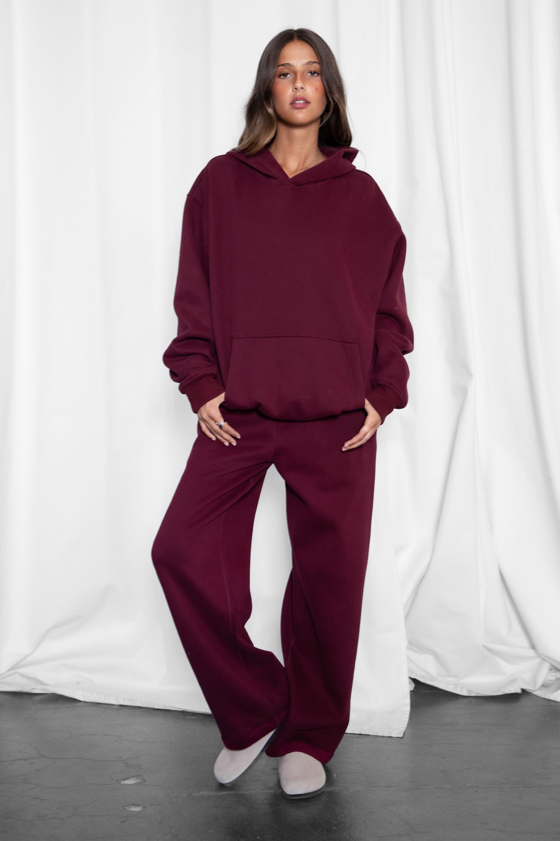Woman wearing the TIC TOC PJ30241 LANI black cherry cloud fleece wide leg sweatpants featuring a straight leg silhouette, drawcord waistband, and side pockets paired with a matching sweater.