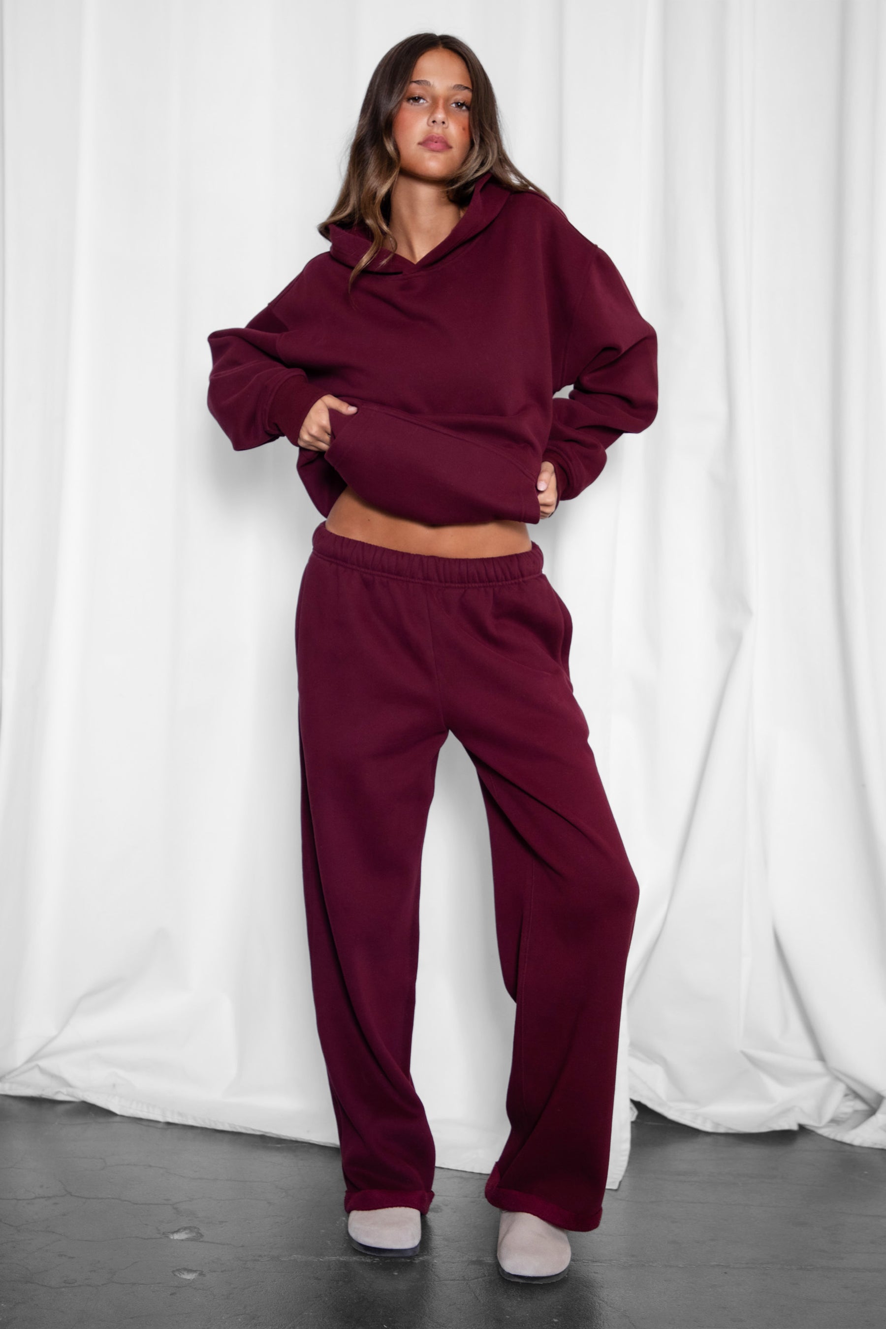 Woman wearing the TIC TOC PJ30241 LANI black cherry cloud fleece wide leg sweatpants featuring a straight leg silhouette, drawcord waistband, and side pockets paired with a matching sweater.
