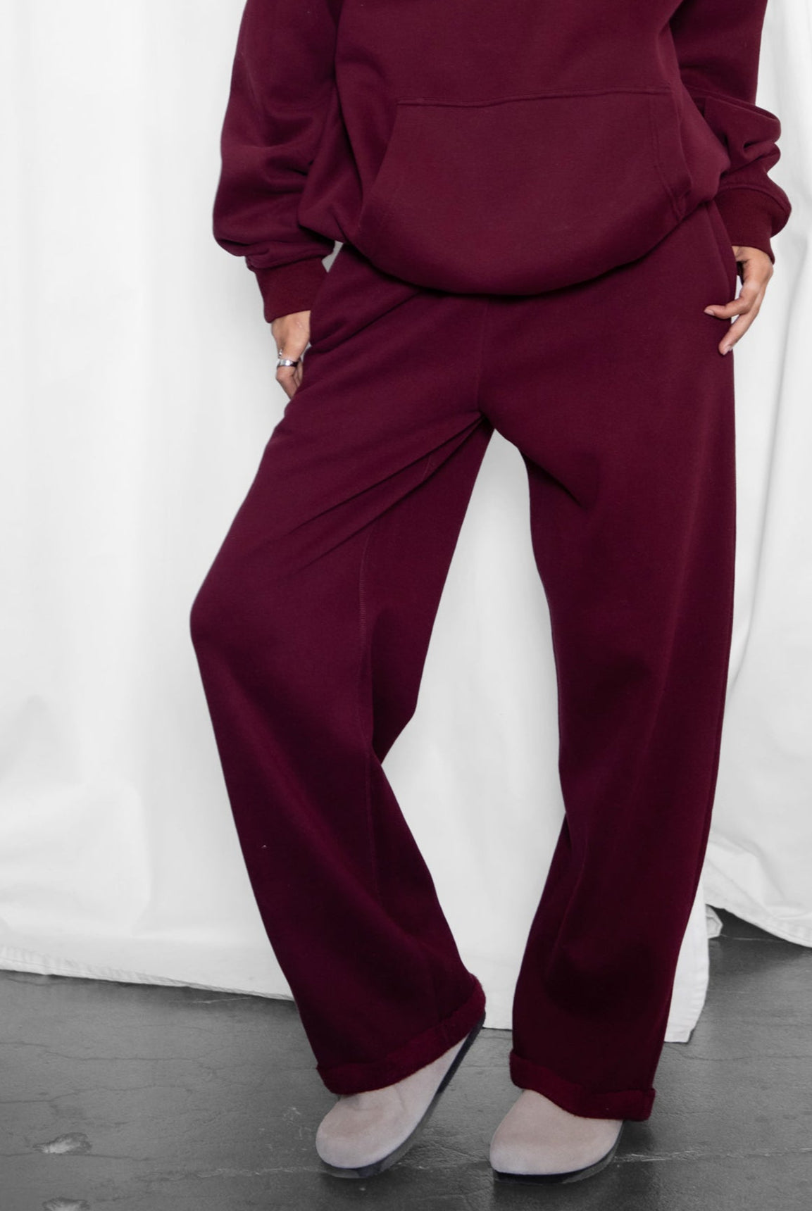 Woman wearing the TIC TOC PJ30241 LANI black cherry cloud fleece wide leg sweatpants featuring a straight leg silhouette, drawcord waistband, and side pockets paired with a matching sweater.