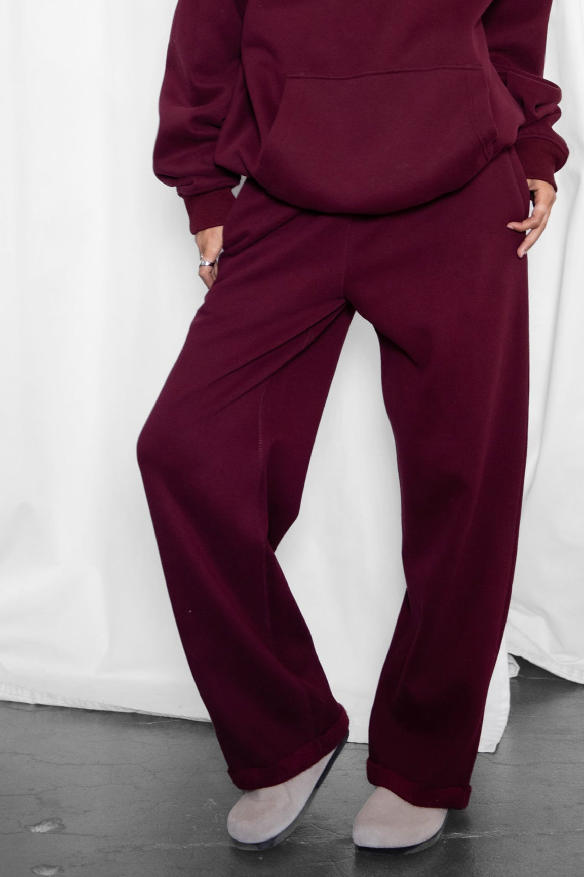 Woman wearing the TIC TOC PJ30241 LANI black cherry cloud fleece wide leg sweatpants featuring a straight leg silhouette, drawcord waistband, and side pockets paired with a matching sweater.