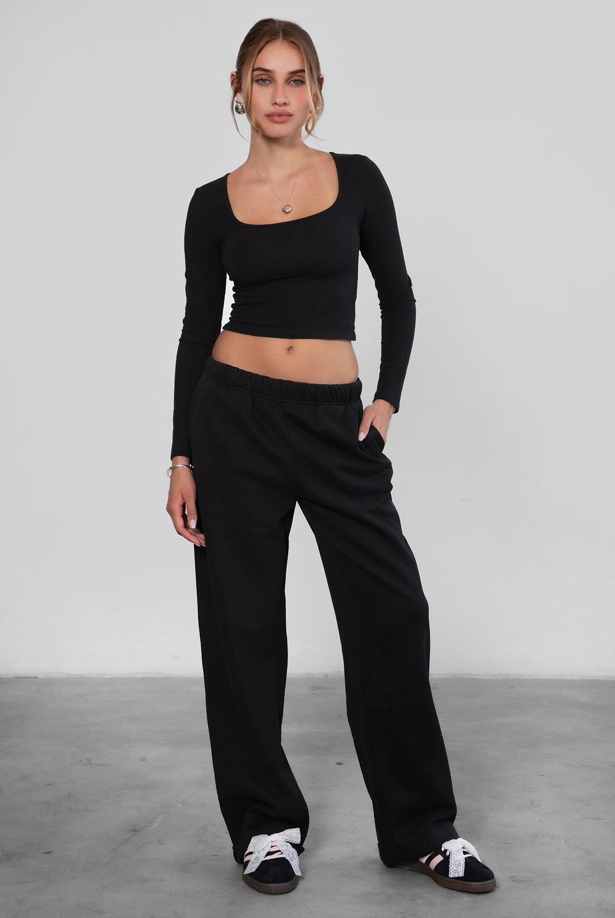 Woman wearing the TIC TOC PJ30241 LANI black cloud fleece wide leg sweatpants featuring a straight leg silhouette, drawcord waistband, and side pockets paired with a matching sweater.