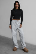 Woman wearing the TIC TOC PJ30241 LANI heather grey cloud fleece wide leg sweatpants featuring a straight leg silhouette, drawcord waistband, and side pockets paired with a matching sweater.