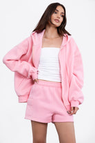 Blush pink oversized hoodie with a full zipper and adjustable drawstring for a cozy feel by Tic Toc.