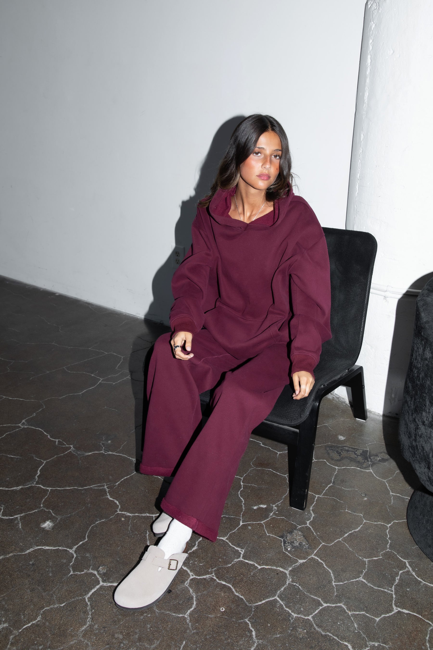 Woman wearing the TIC TOC TJ31007 DAMI black cherry cloud fleece oversized hoodie featuring a dropped shoulder design, kangaroo pocket, and ribbed cuffs with matching bottoms.